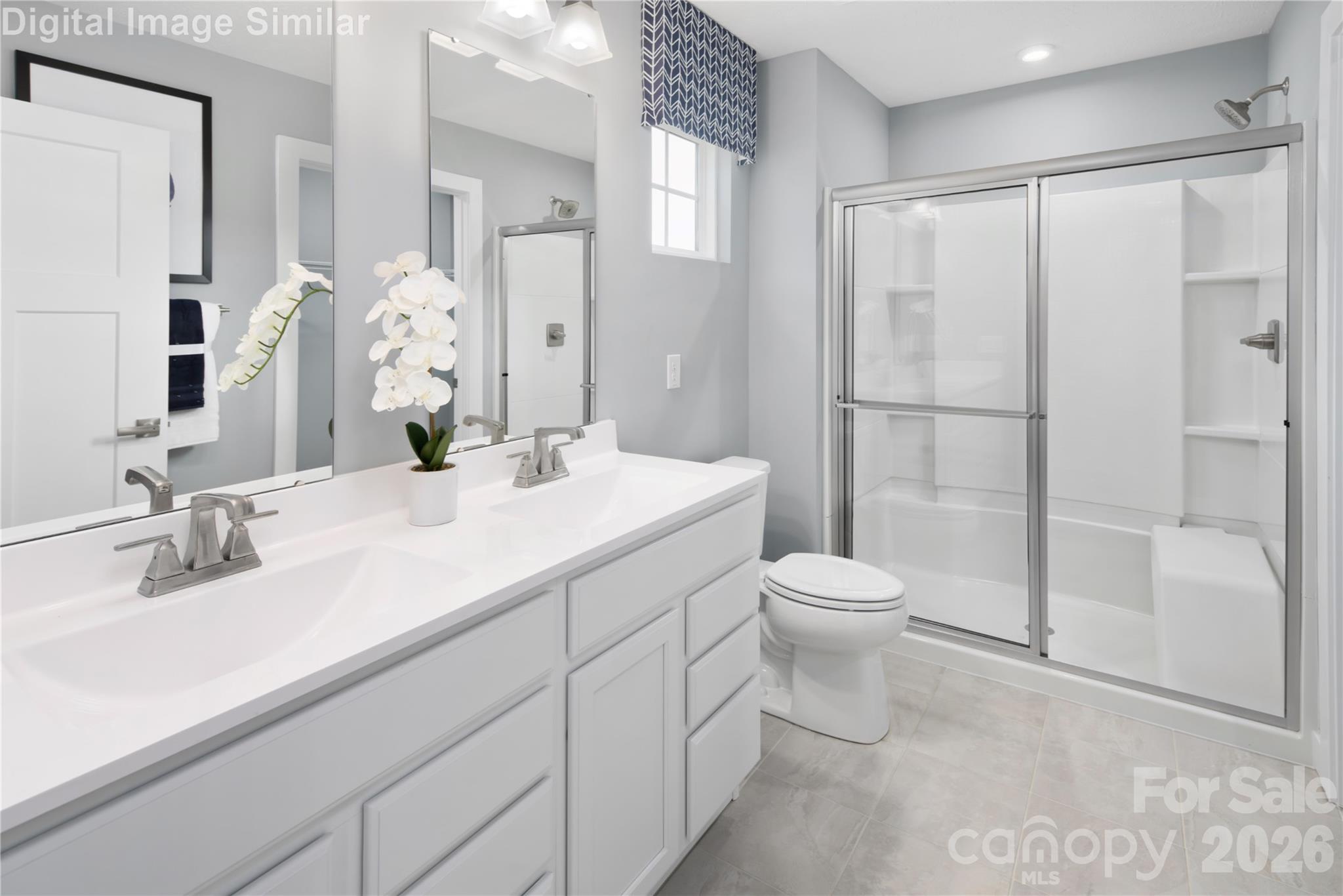 A beautifully appointed ensuite bathroom with a sleek framed shower door and polished, refined details throughout. - 333 Linwood Estates Drive, Lexington