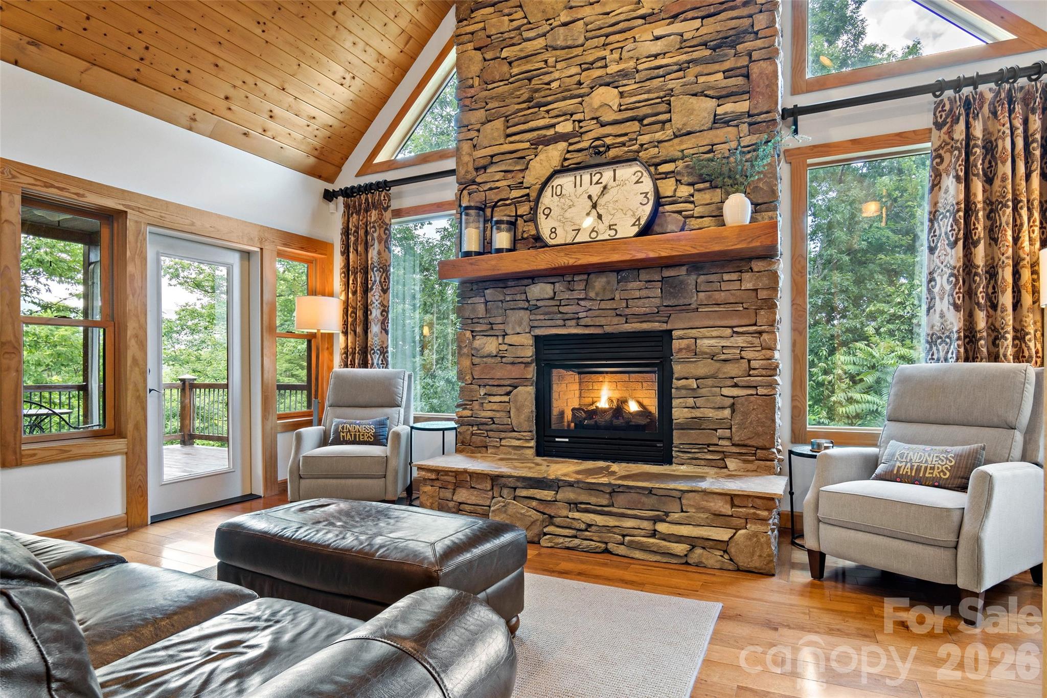 This stately living room features a gas log fireplace and an abundance of natural light. - 179 Rock Spring Road, Lake Lure