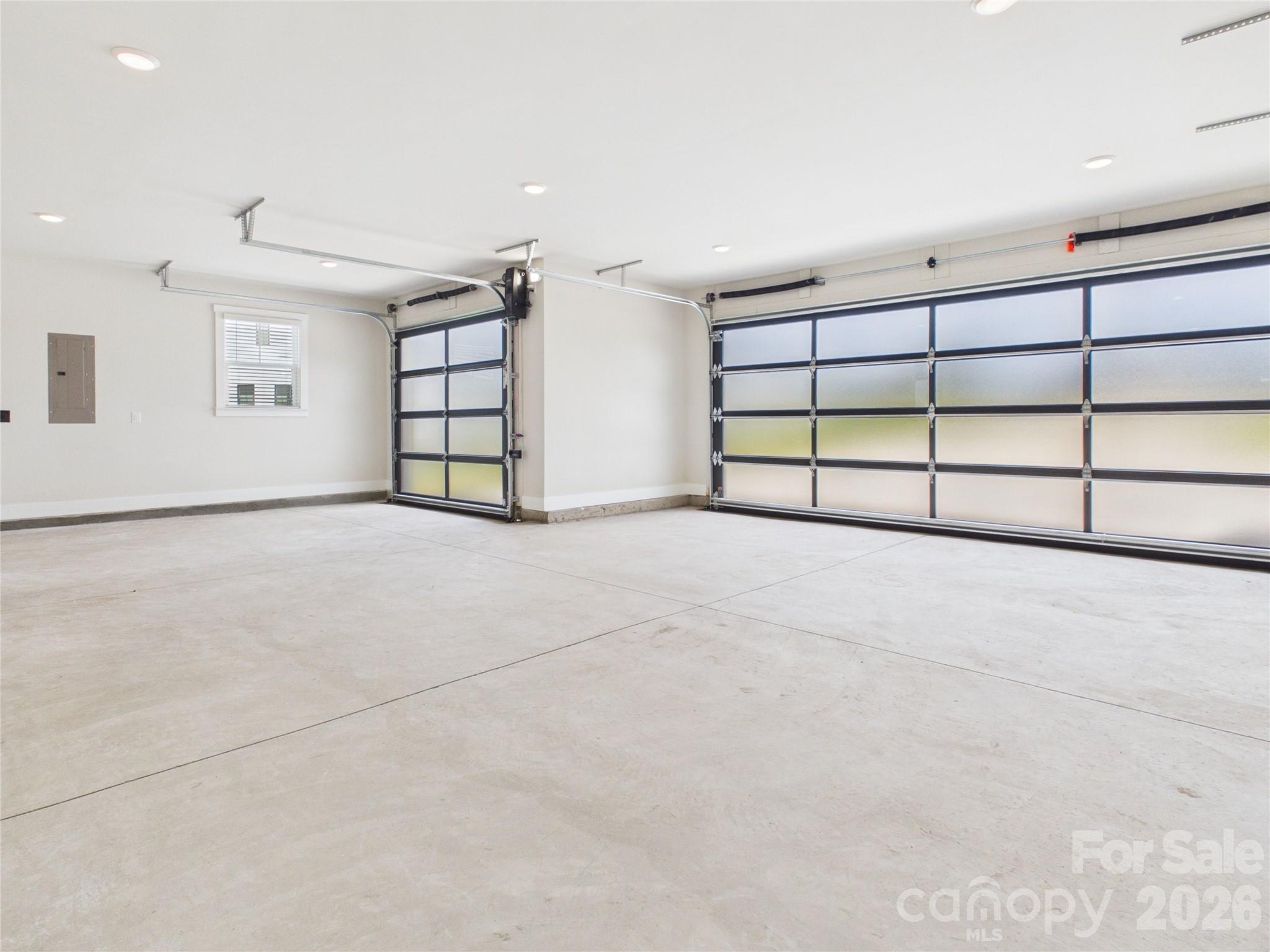 Oversized 3-car garage with insulated walls, 8' garage doors and an outlet for an E/V charger. - 1065 Rolling Meadows Drive, Mooresville