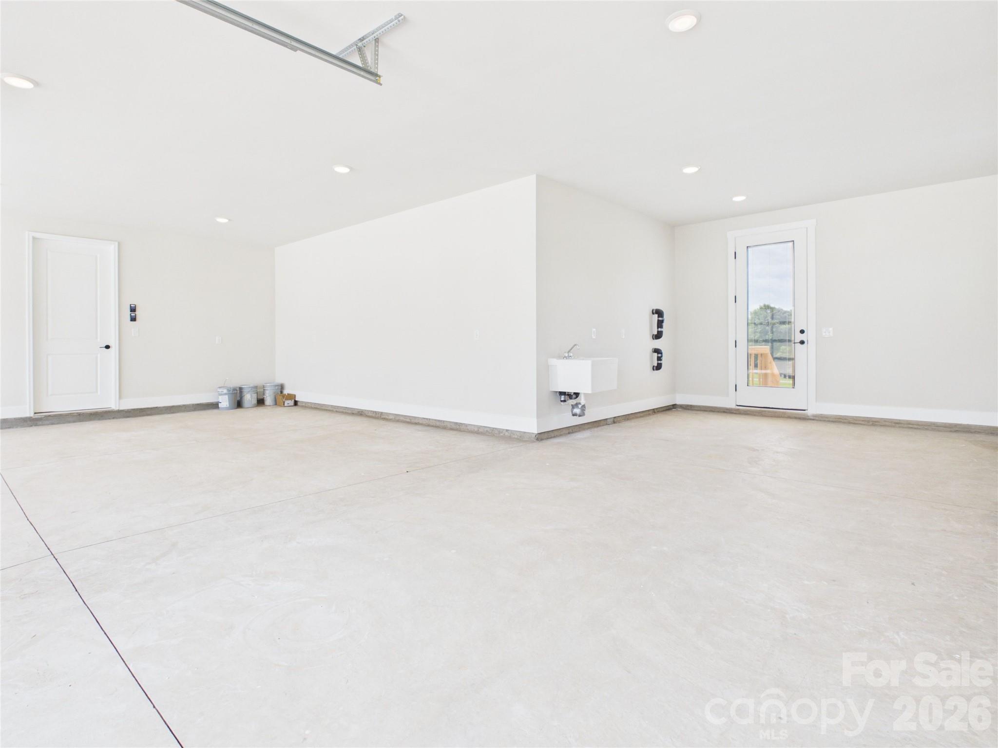 Storage Space/workshop area with utility sink and door to the back yard. - 1065 Rolling Meadows Drive, Mooresville
