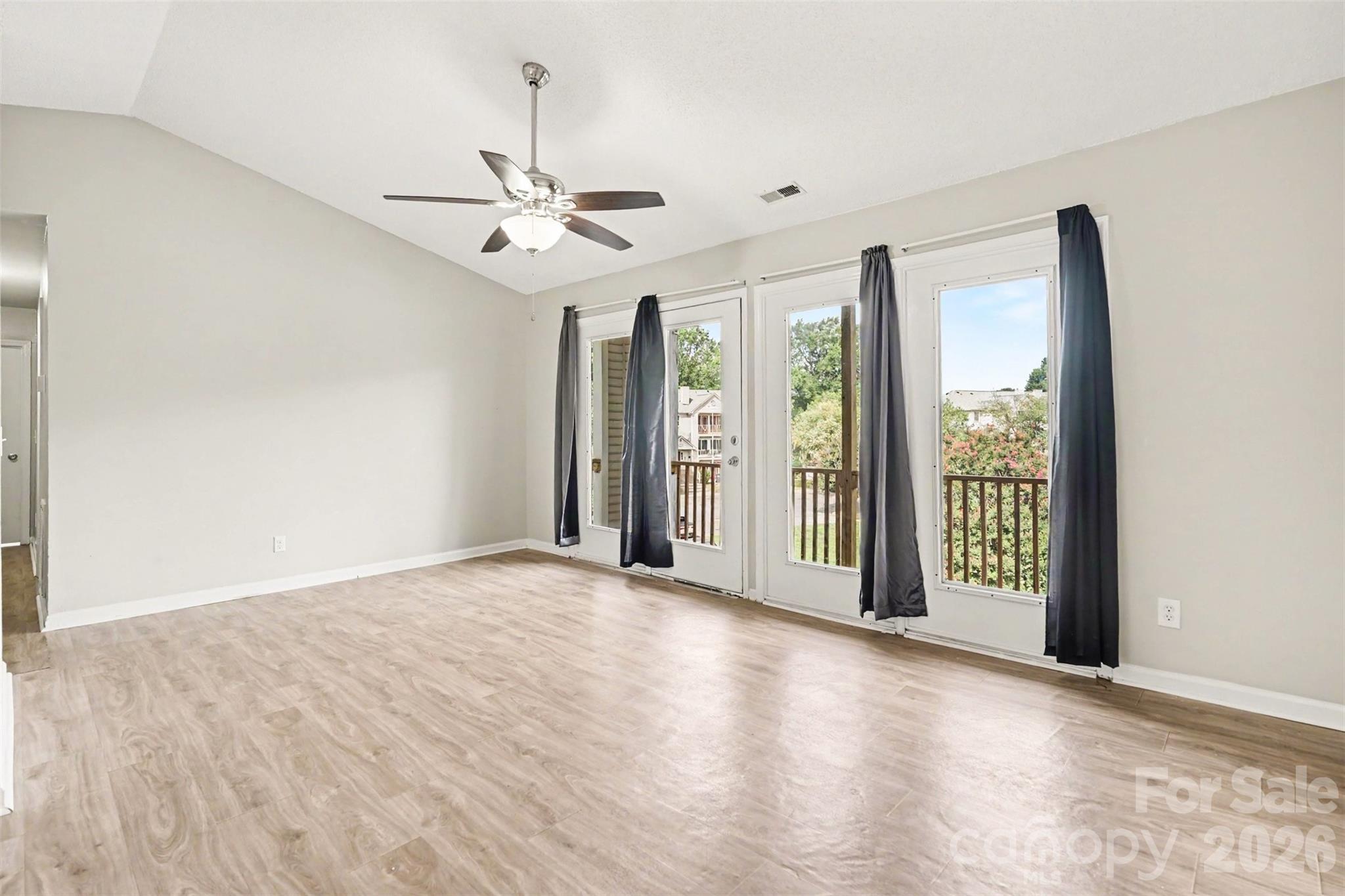 Enter into the large living room and dining area. - 6165 Meadow Rose Lane, Charlotte