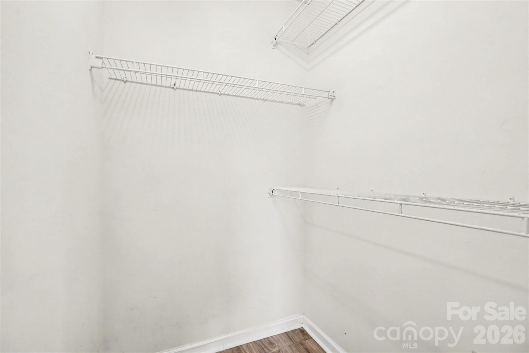 Primary bedroom's large walk-in closet. - 6165 Meadow Rose Lane, Charlotte
