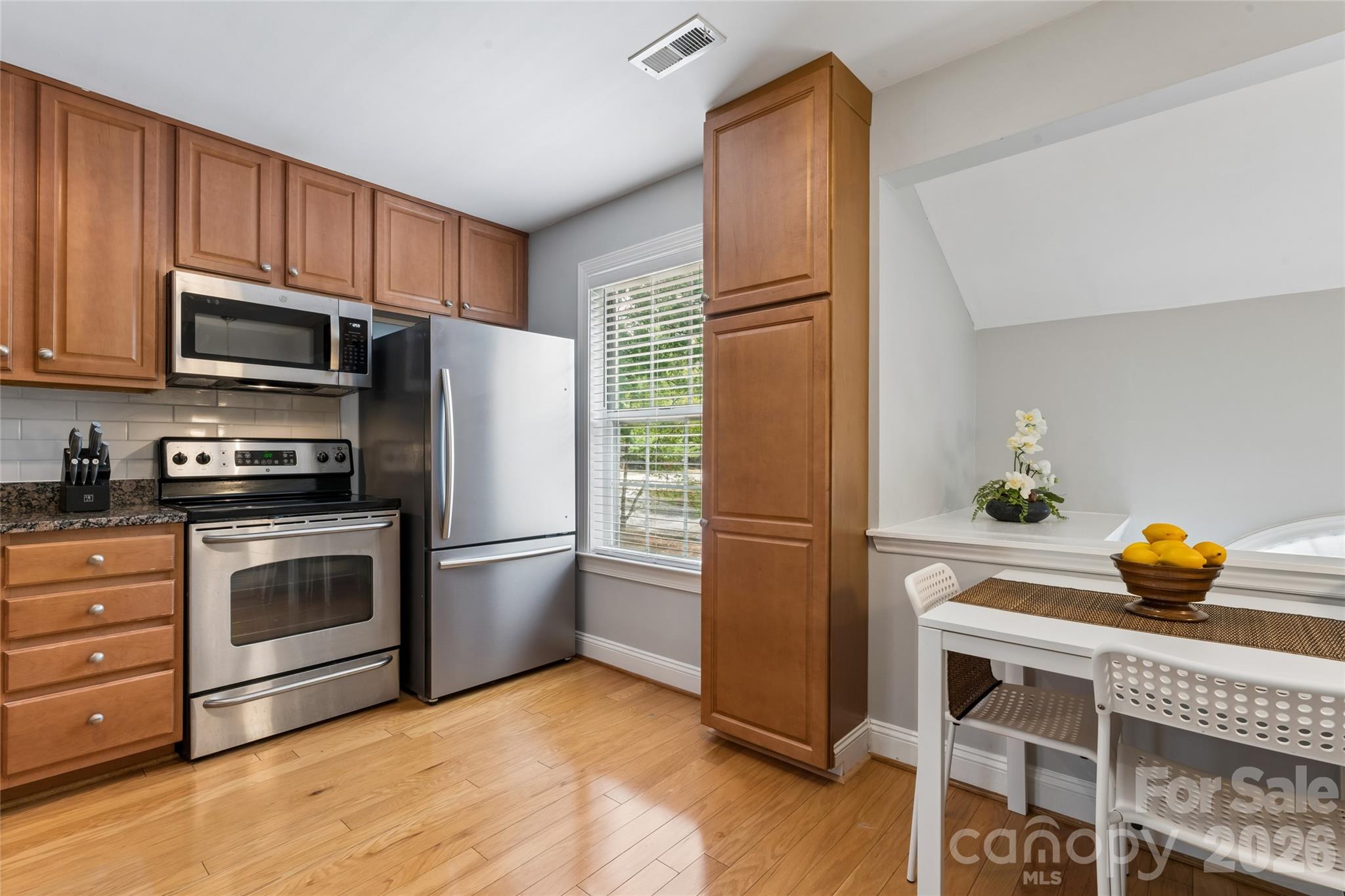 Beautiful hardwood Flooring in Kitchen. Added cabinets for pantry space - 1806 Fairlawn Court, Rock Hill