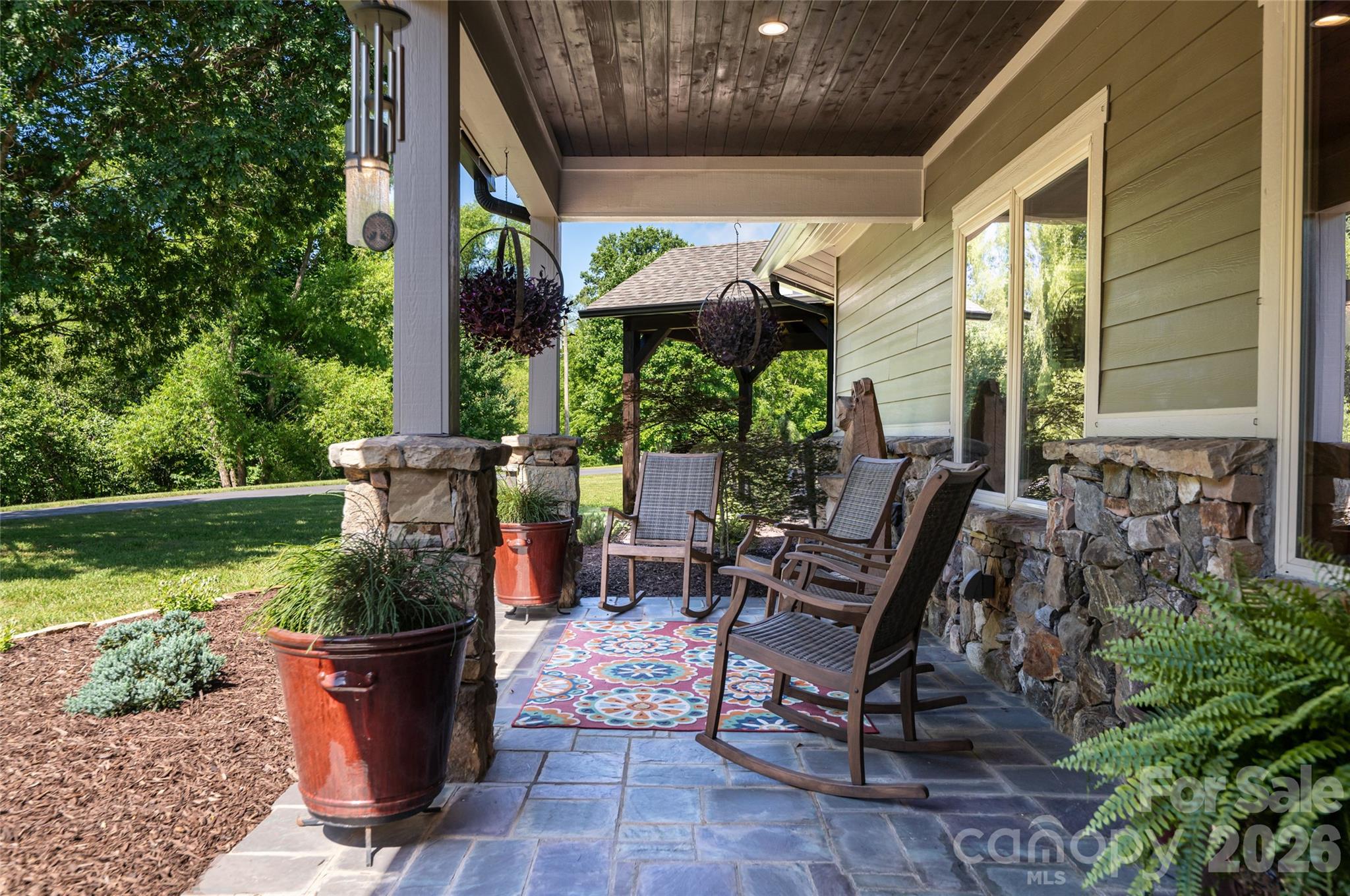 The front porch is the perfect place for morning coffee or an afternoon read. - 660 Pleasant Grove Road, Hendersonville