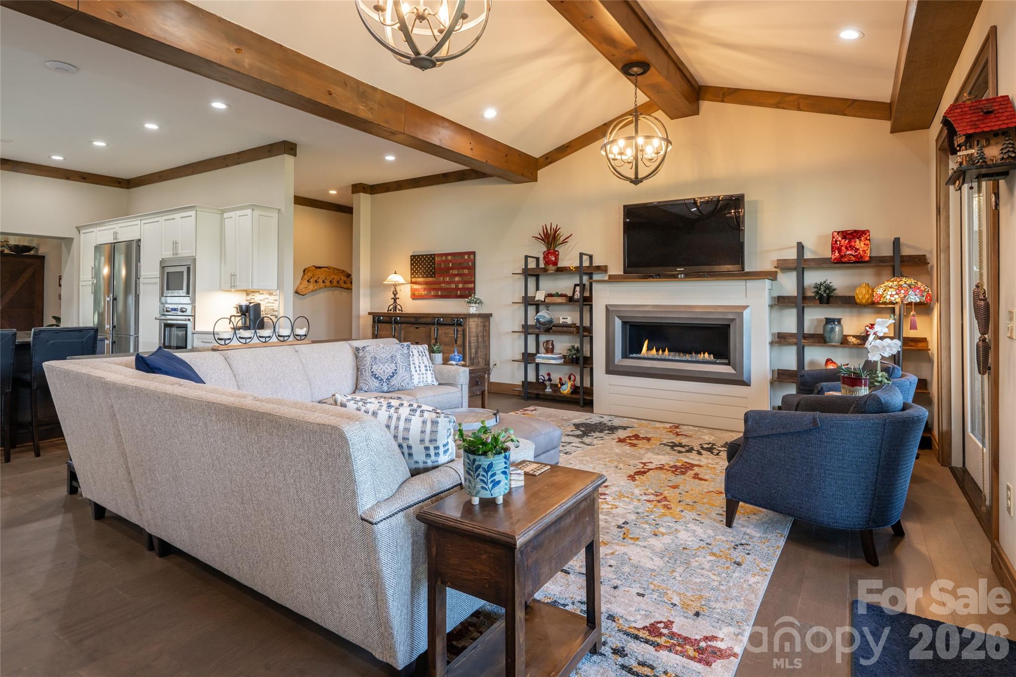 Living room with cathedral ceiling and modern gas fireplace. - 660 Pleasant Grove Road, Hendersonville