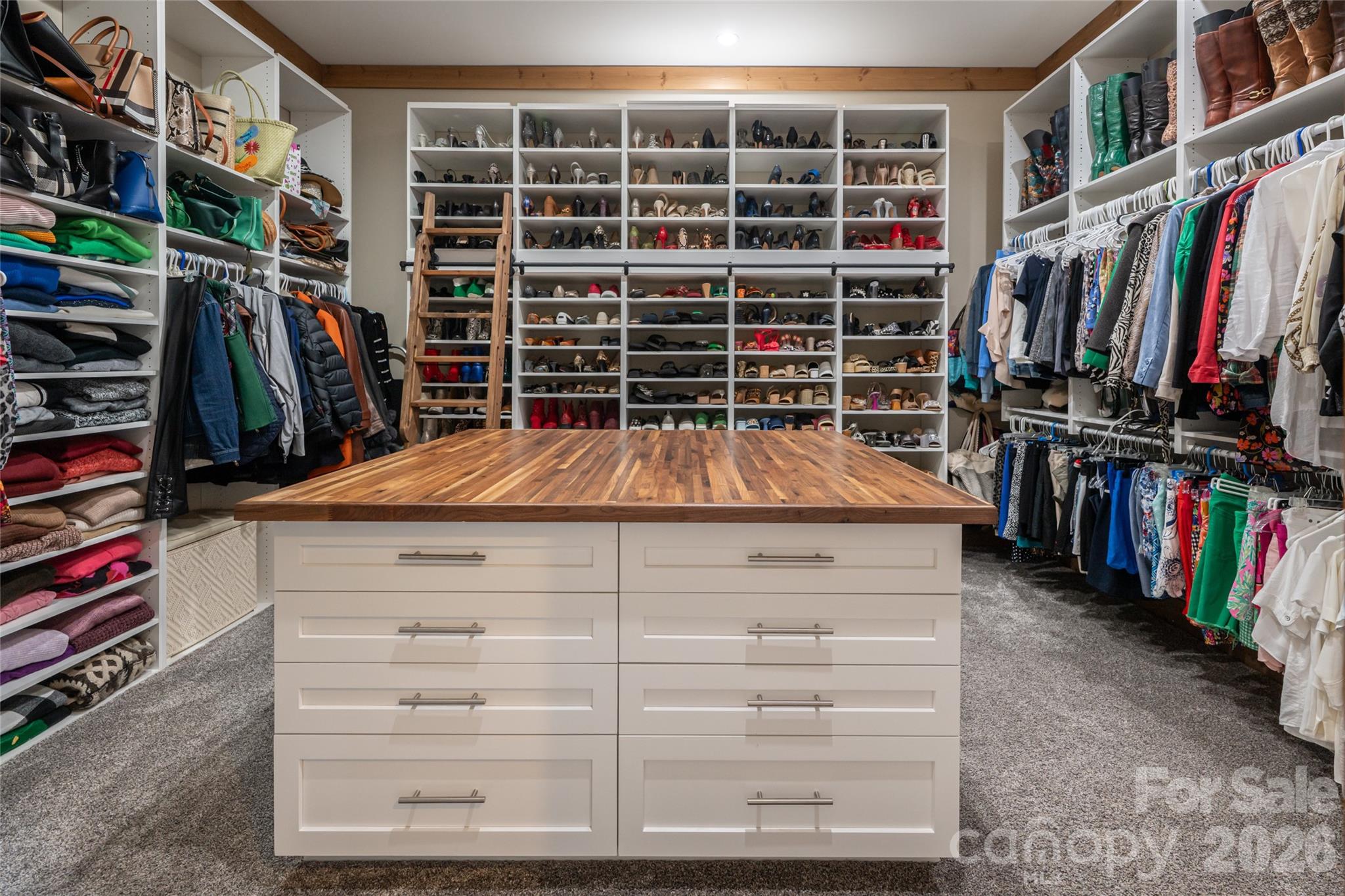 HER walk-in closet with large island with drawers on each side. - 660 Pleasant Grove Road, Hendersonville