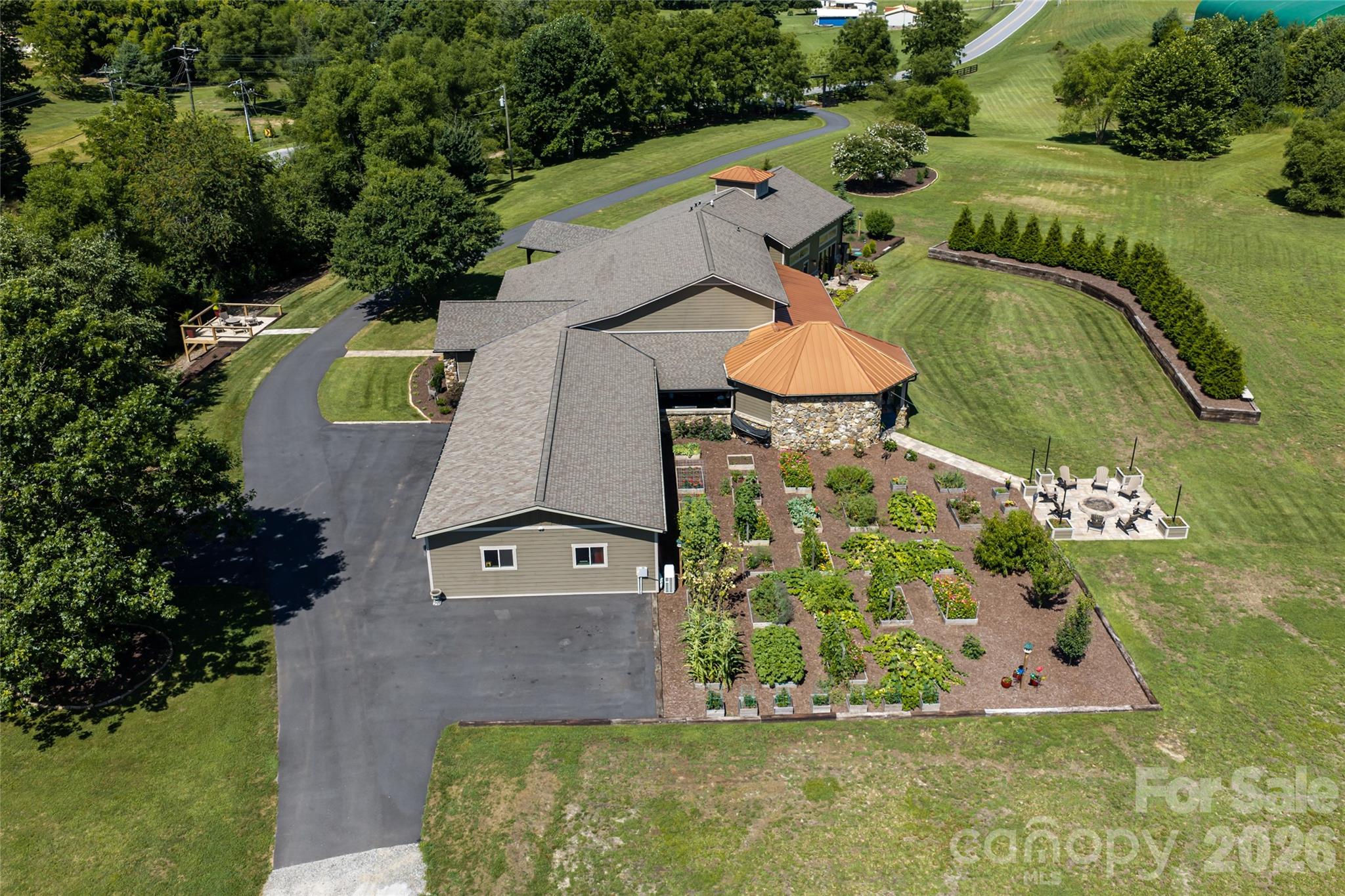 Aerial perspective showcasing easy to maintain raised beds and distinctive copper roofing. - 660 Pleasant Grove Road, Hendersonville