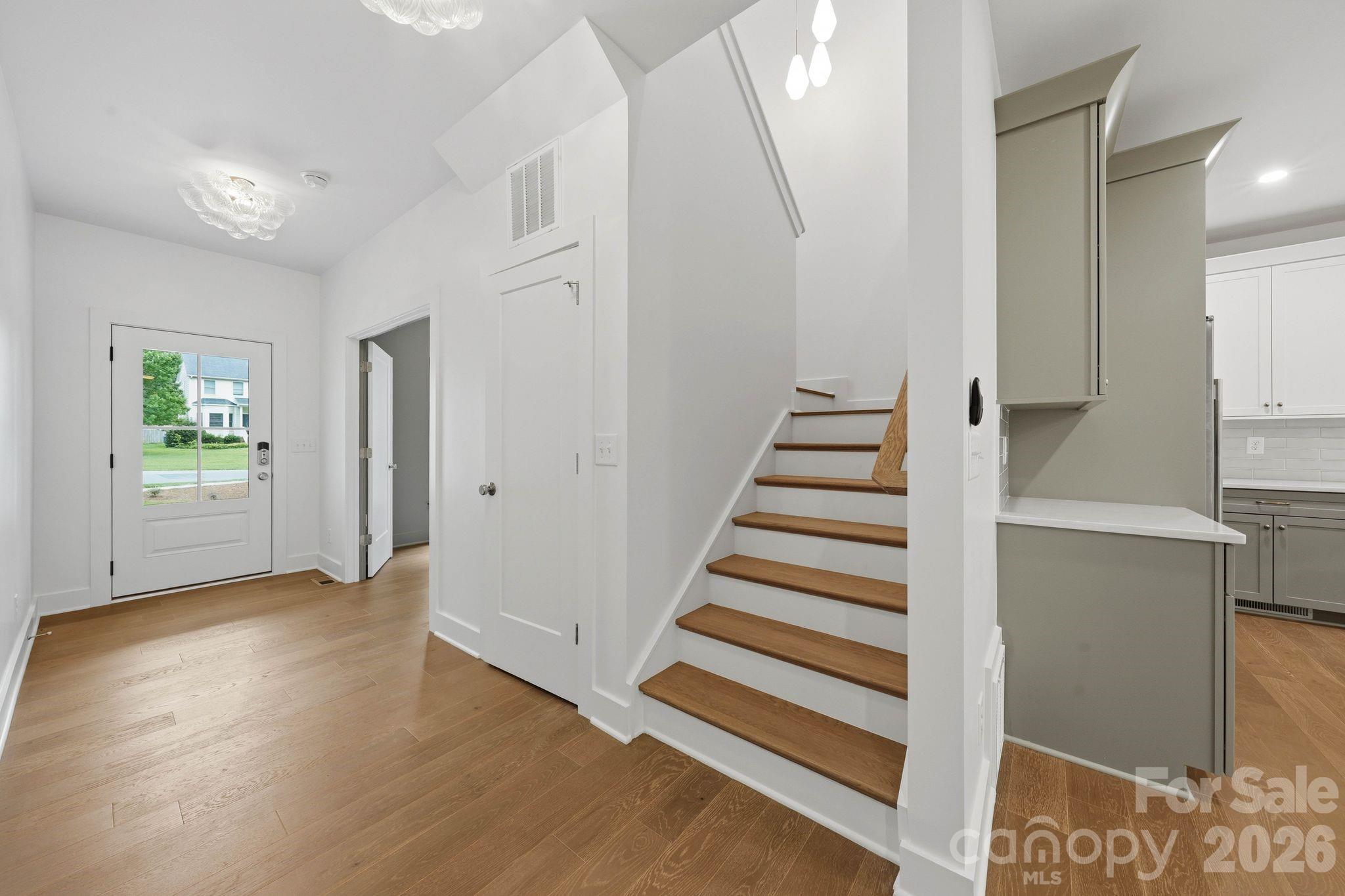 Stairwell to upper level. - 2311 Chateau Court, Matthews