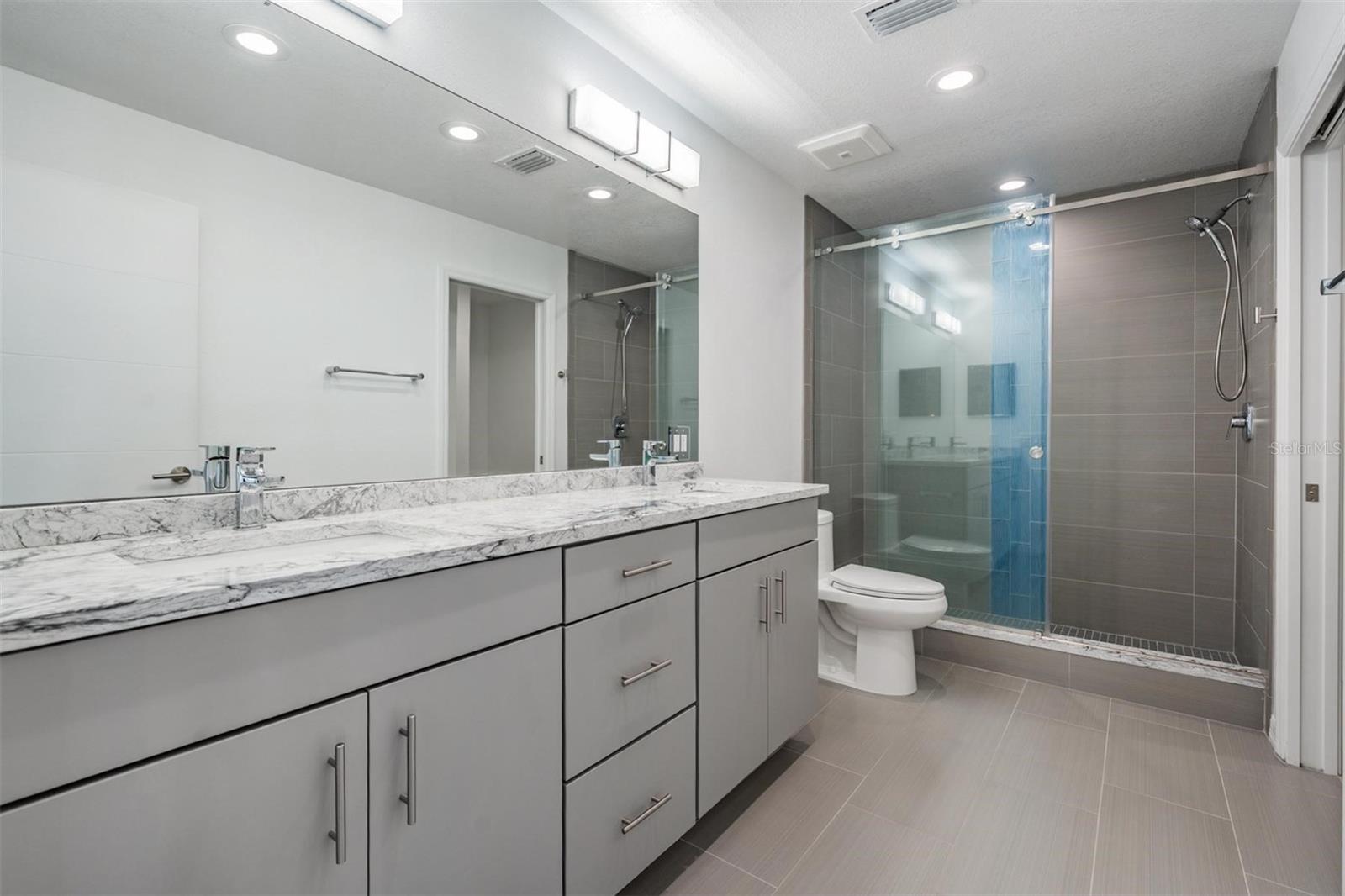 Master #2 Bathroom with Dual Vanities, Large Shower and Storage - 243 MARINER DR #243, TARPON SPRINGS