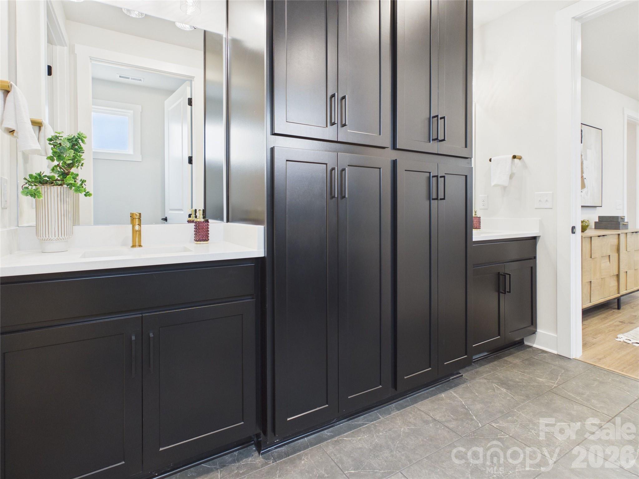 2nd Primary Bathroom with Built in cabinetry with rollouts for easy storage. - 1065 Rolling Meadows Drive, Mooresville