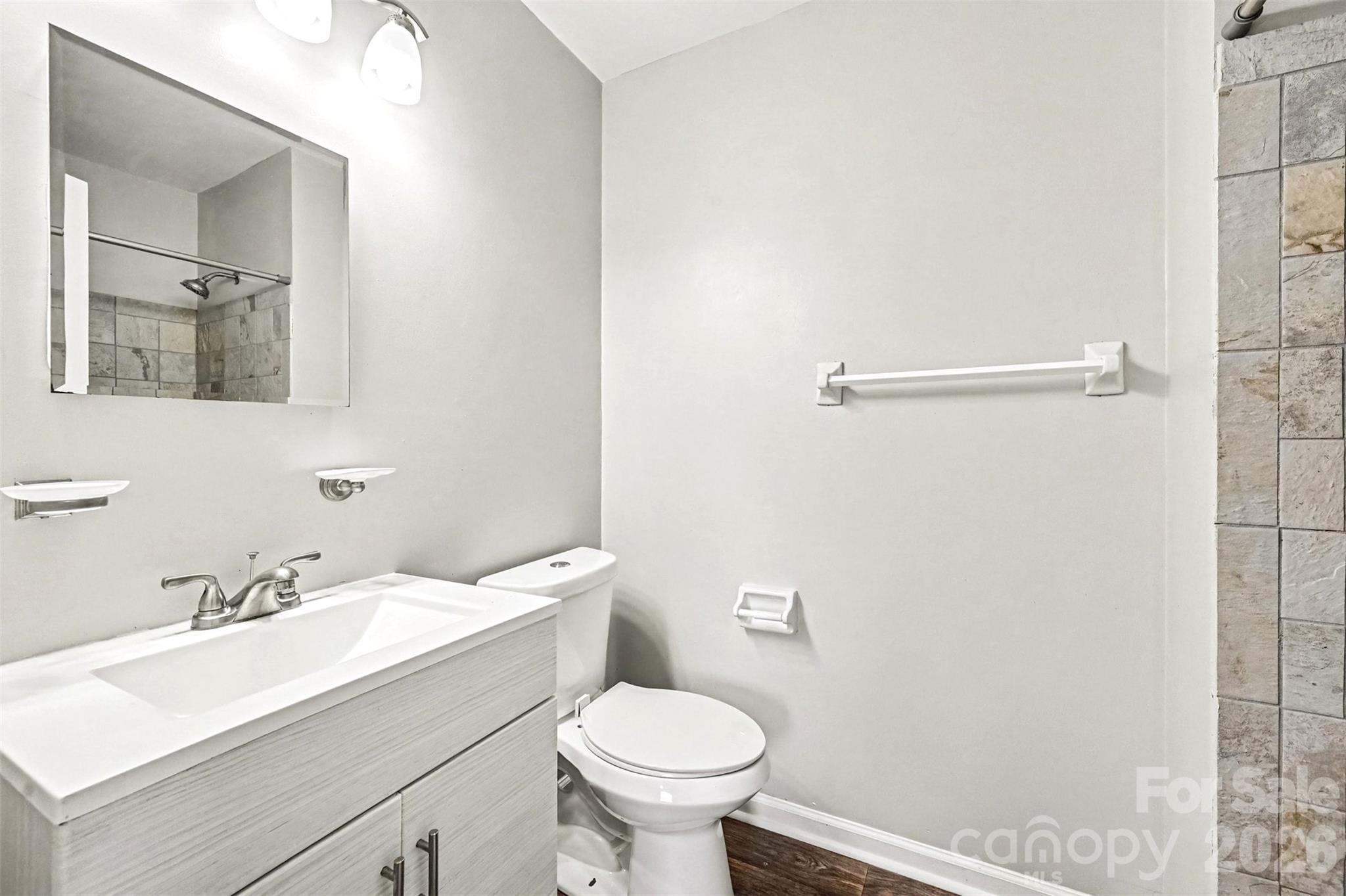 Primary bathroom - updated lighting, new vanity with solid surface sink and counter and more... - 6165 Meadow Rose Lane, Charlotte