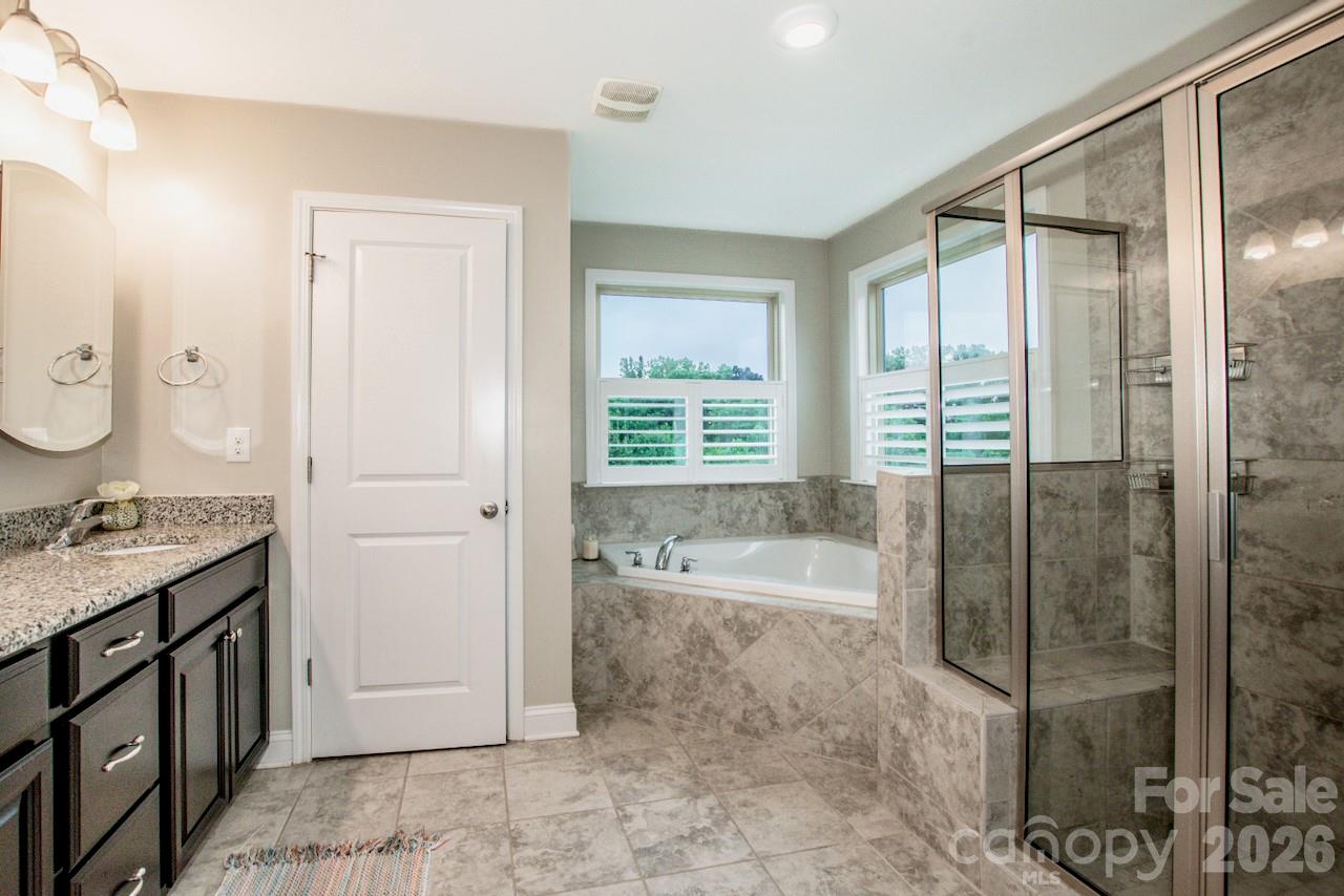Beautifully tiled primary bathroom - 130 Eagles Landing Drive, Mooresville