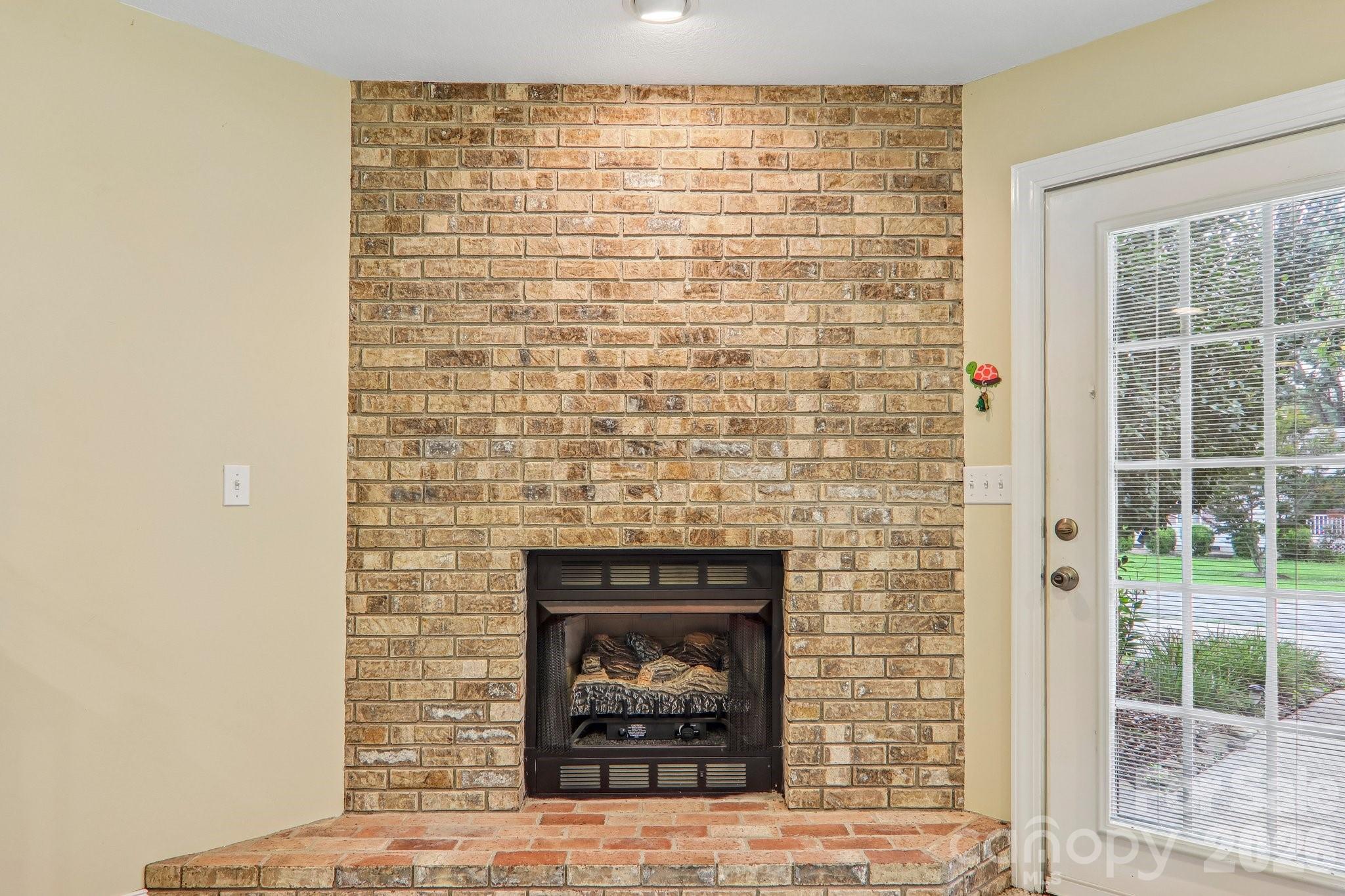 Natural gas fireplace with brick surround - 3311 Sandy Drive, Hendersonville