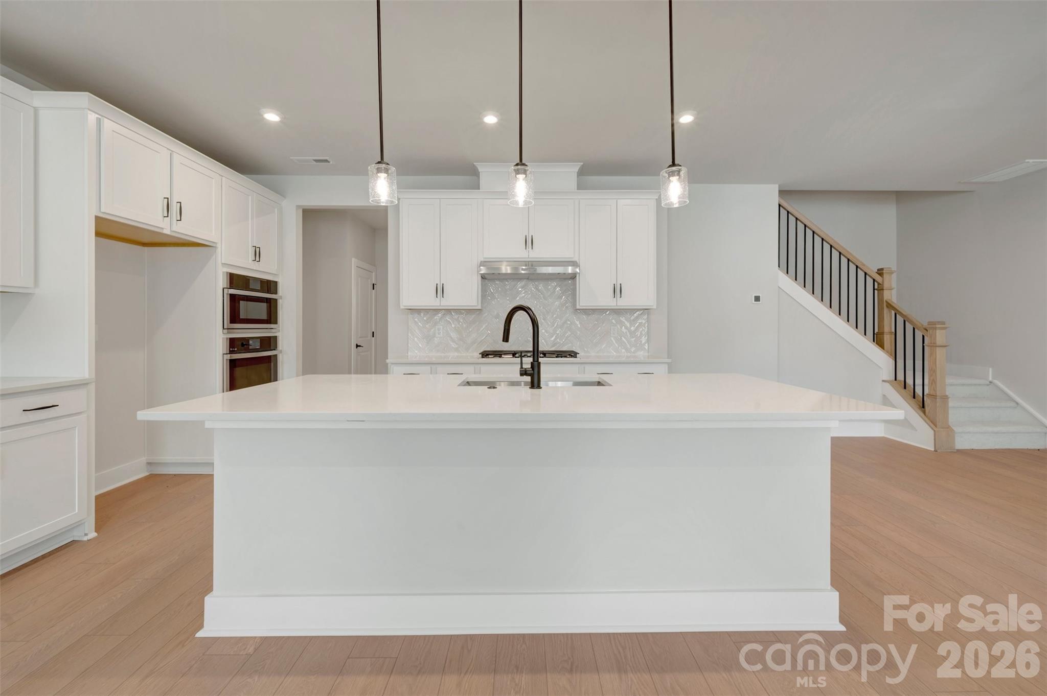 Kitchen with white cabinets and white quartz countertops - 314 Ardmore Drive, Belmont
