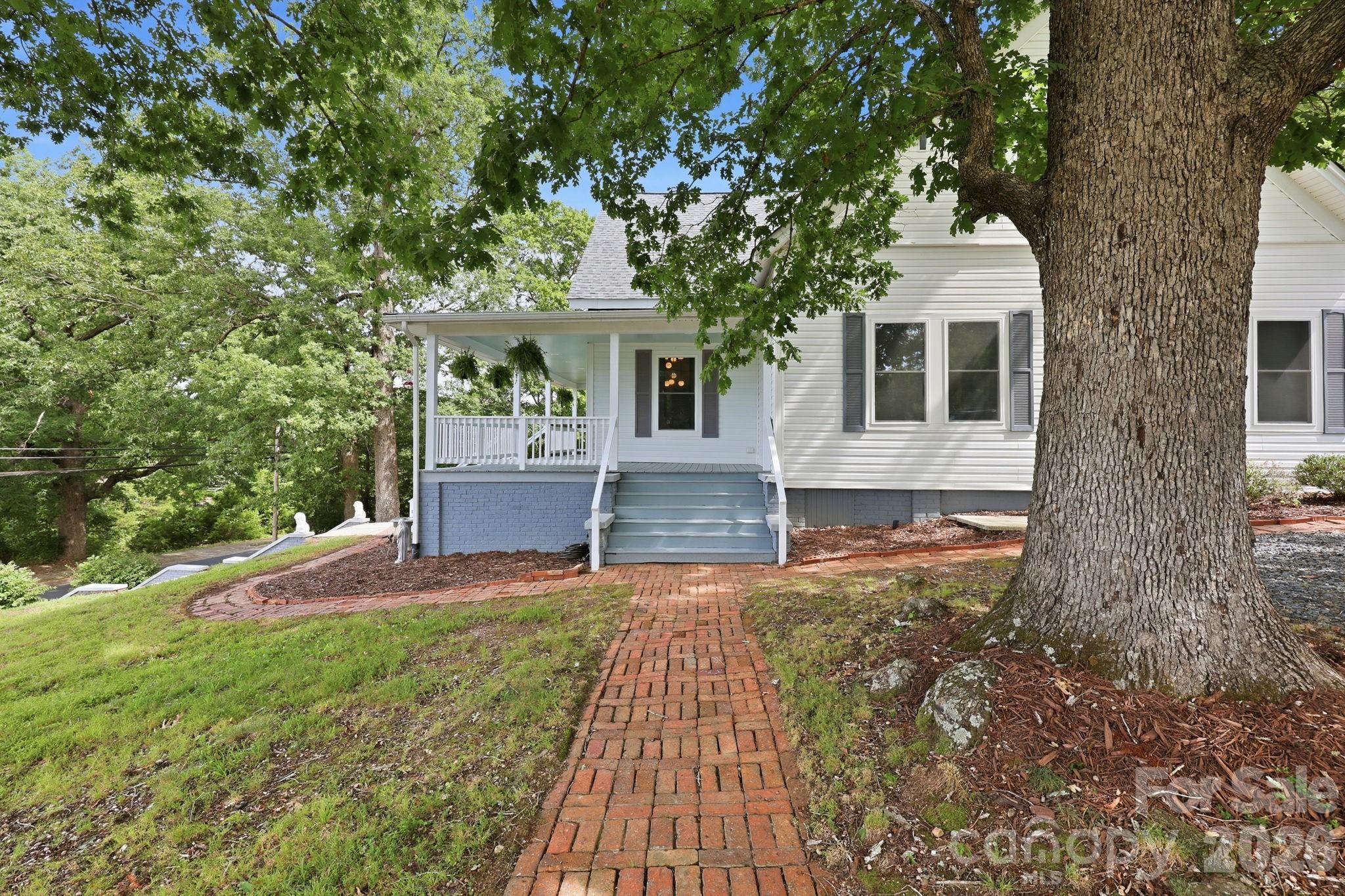 Brick walkways around the side and front of the home add an old world charm - 527 S 2nd Street, Albemarle