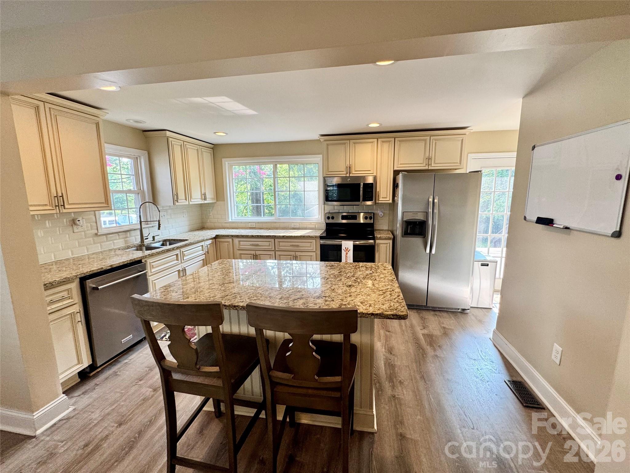 Kitchen with granite countertops, lots of cabinetry and stainless appliances - 205 Tournament Drive SW, Concord