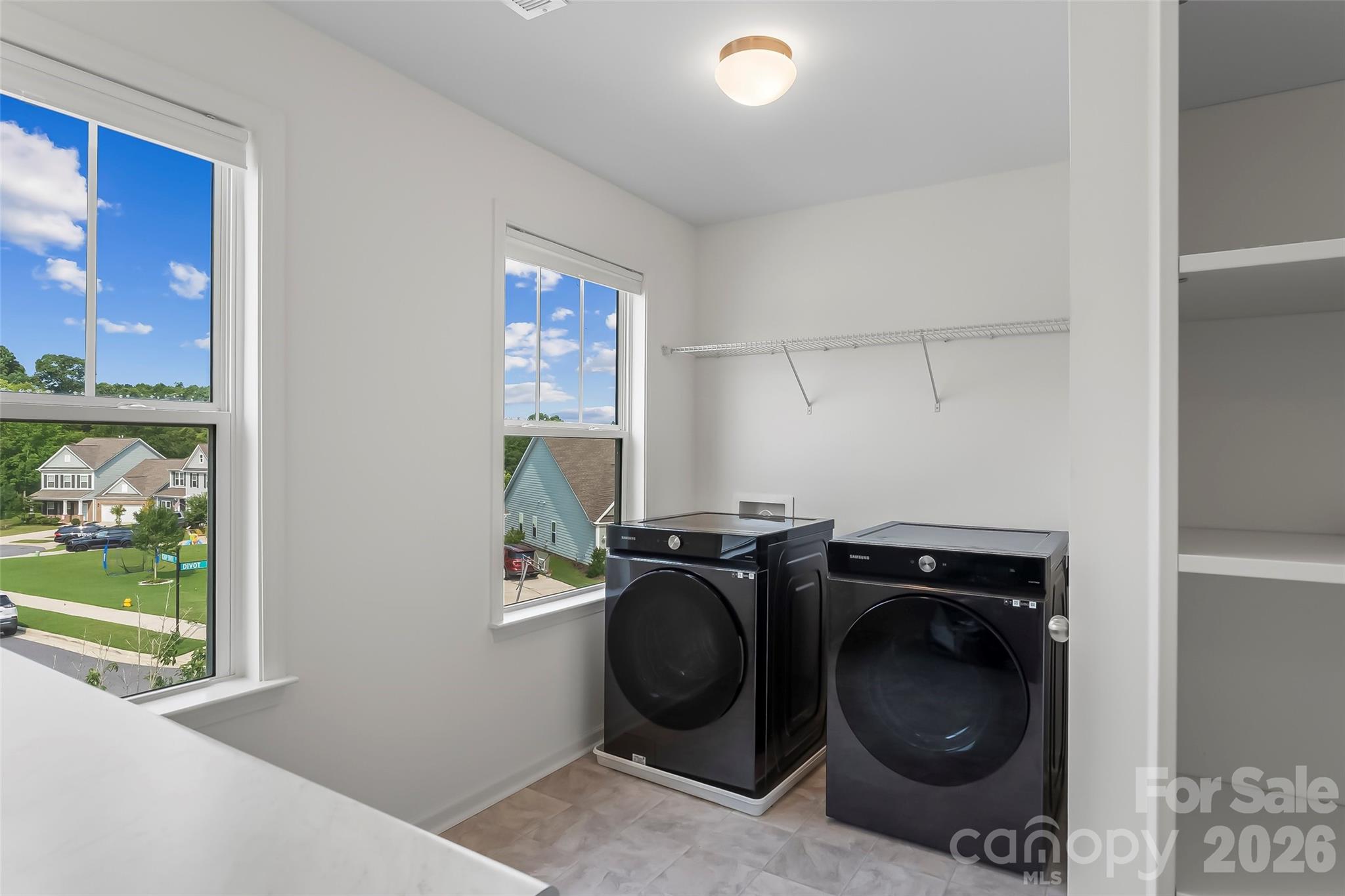 Large Laundry room built in shelving with folding table. Smart Samsung front load washer/ dryer - 112 Divot Lane, Statesville