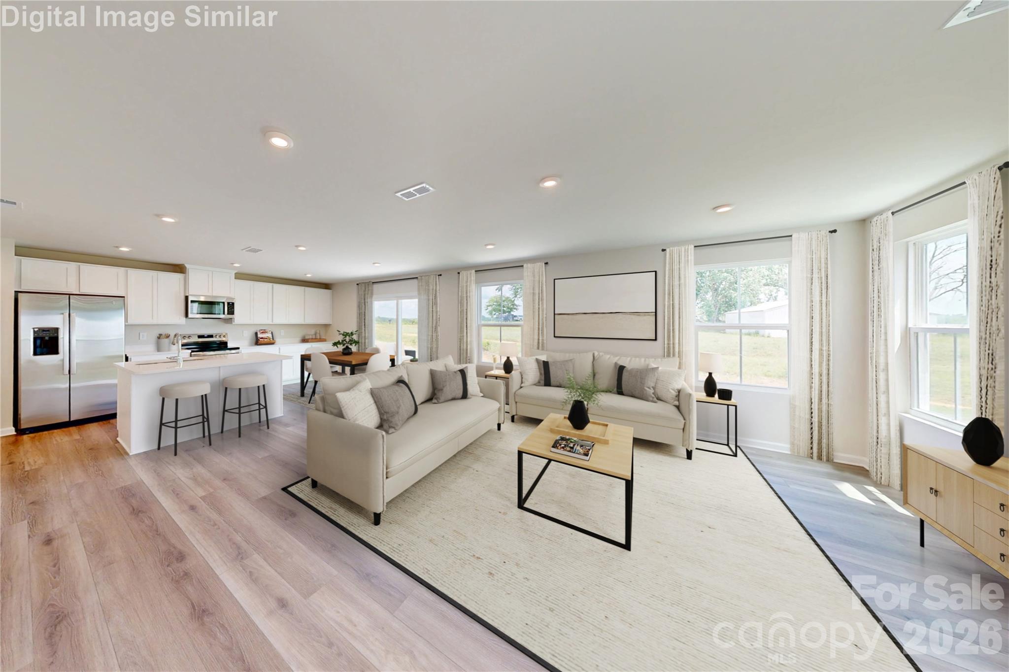 Wide open spaces, sunshine galore! This kitchen and great room combo is bursting with light, style, and room to live your best life! - 1208 Elm Forest Lane, China Grove