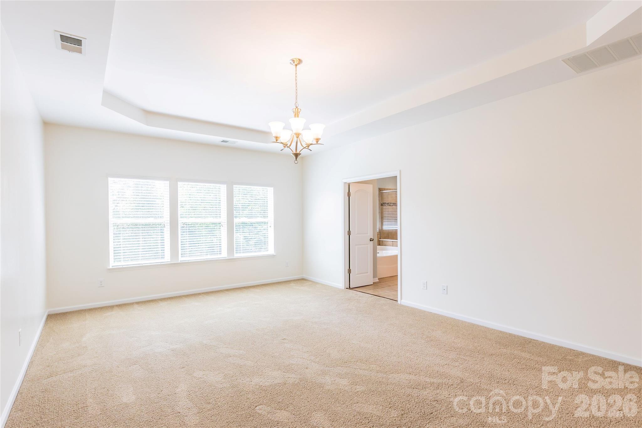 Large Primary Bedroom with lots of natural light. - 404 E Waterlynn Road, Mooresville