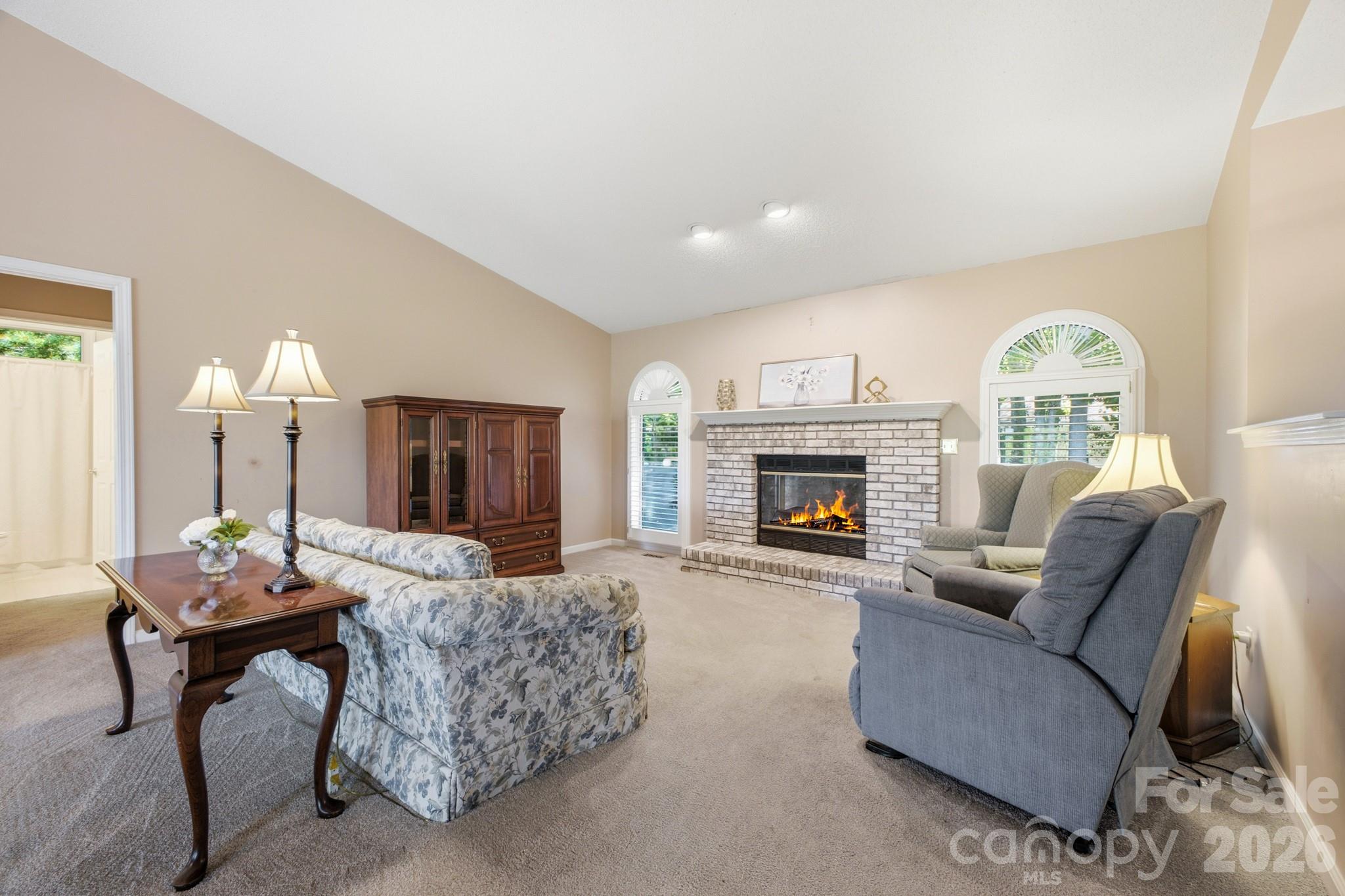 Living room offers custom plantation shutters, fireplae can be gas logs or gas starter for wood burning. - 1870 Riverview Court, Hendersonville