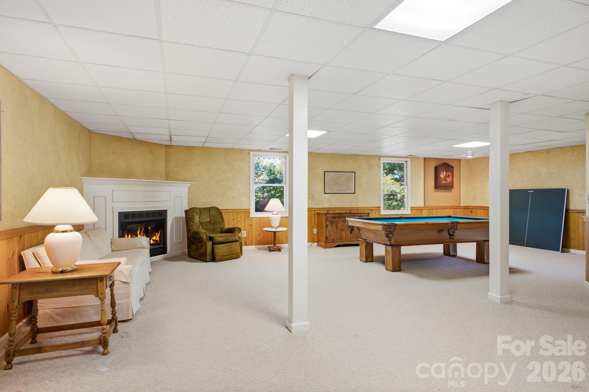 Open Living Area in Lower Level with gas log fireplace - 1870 Riverview Court, Hendersonville