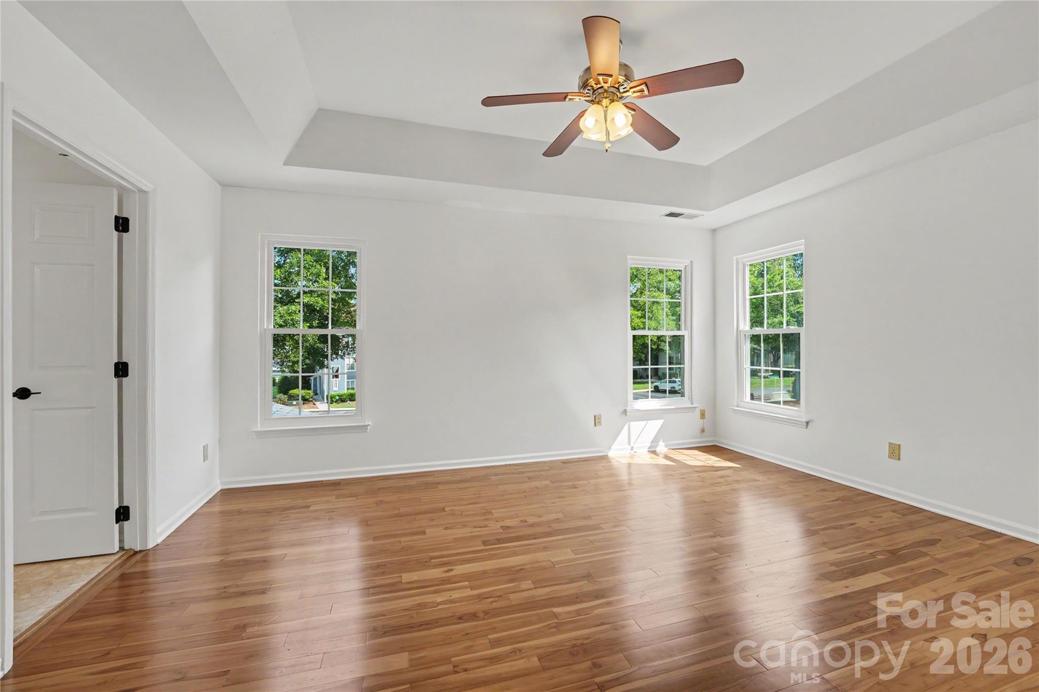 Primary Bedroom with ensuite and tray ceiling. - 17205 Asti Court, Cornelius