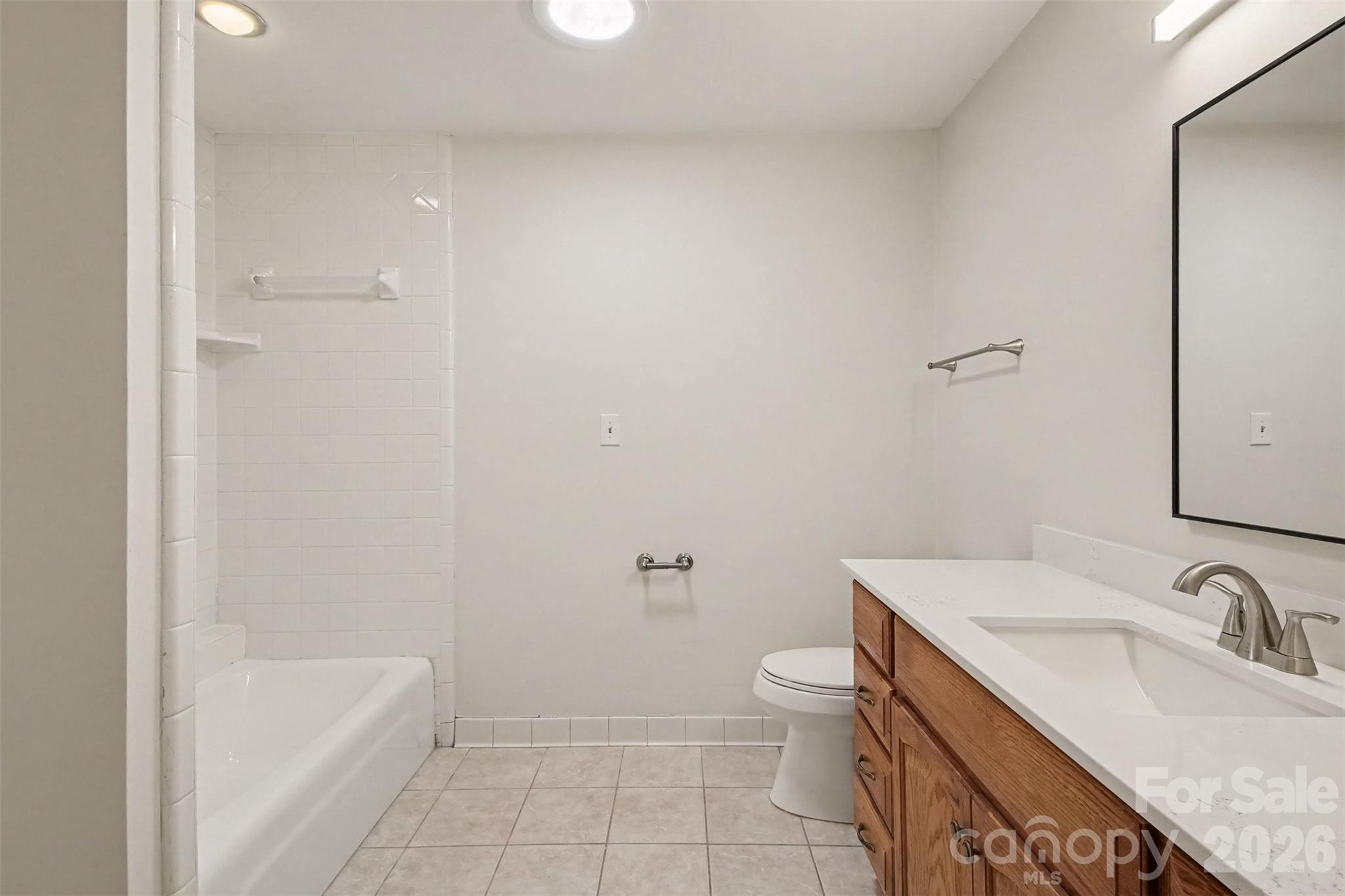 Bathroom 3 has a cast-iron tub and a beautiful new quartz countertop, too. - 13520 Andulusian Drive, Matthews