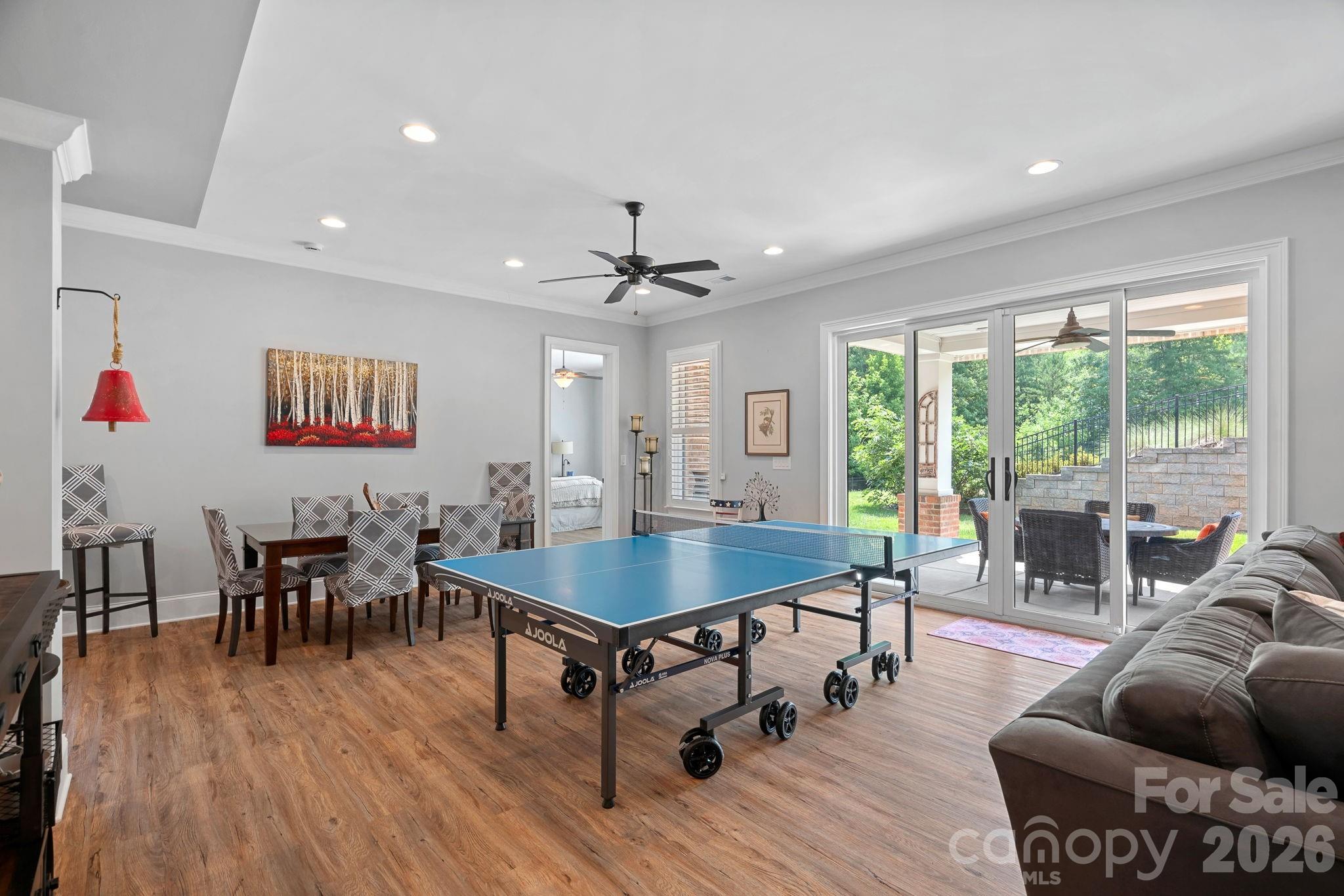 walkout basement with dining area and ping pong area leading out onto the covered patio - 2889 Mount Pleasant Road, Sherrills Ford