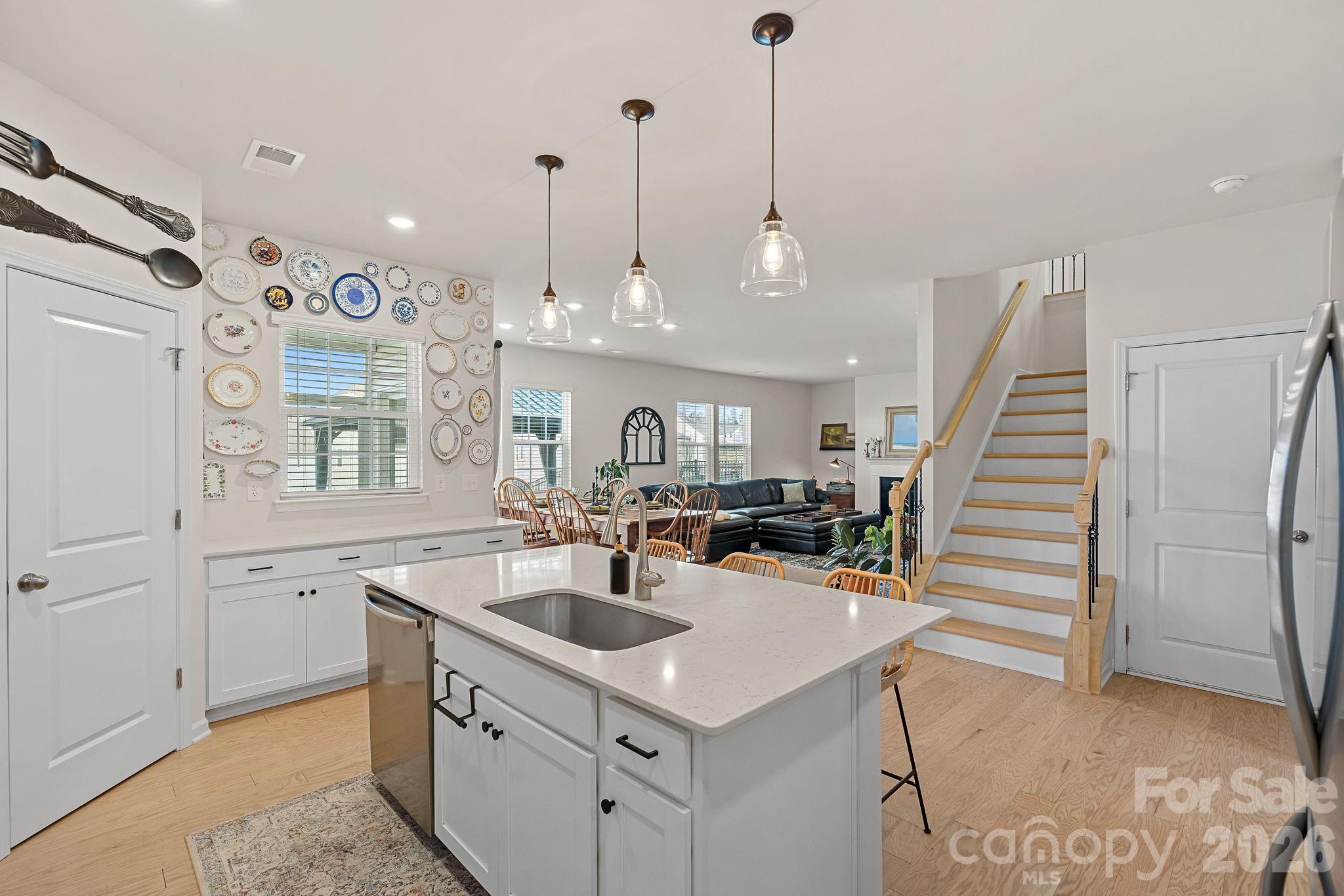 Open concept, light flooring and wooden steps. - 262 Abersham Drive, Mooresville
