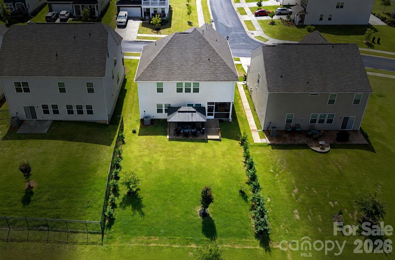 Ever green trees on both sides of the yard. - 262 Abersham Drive, Mooresville