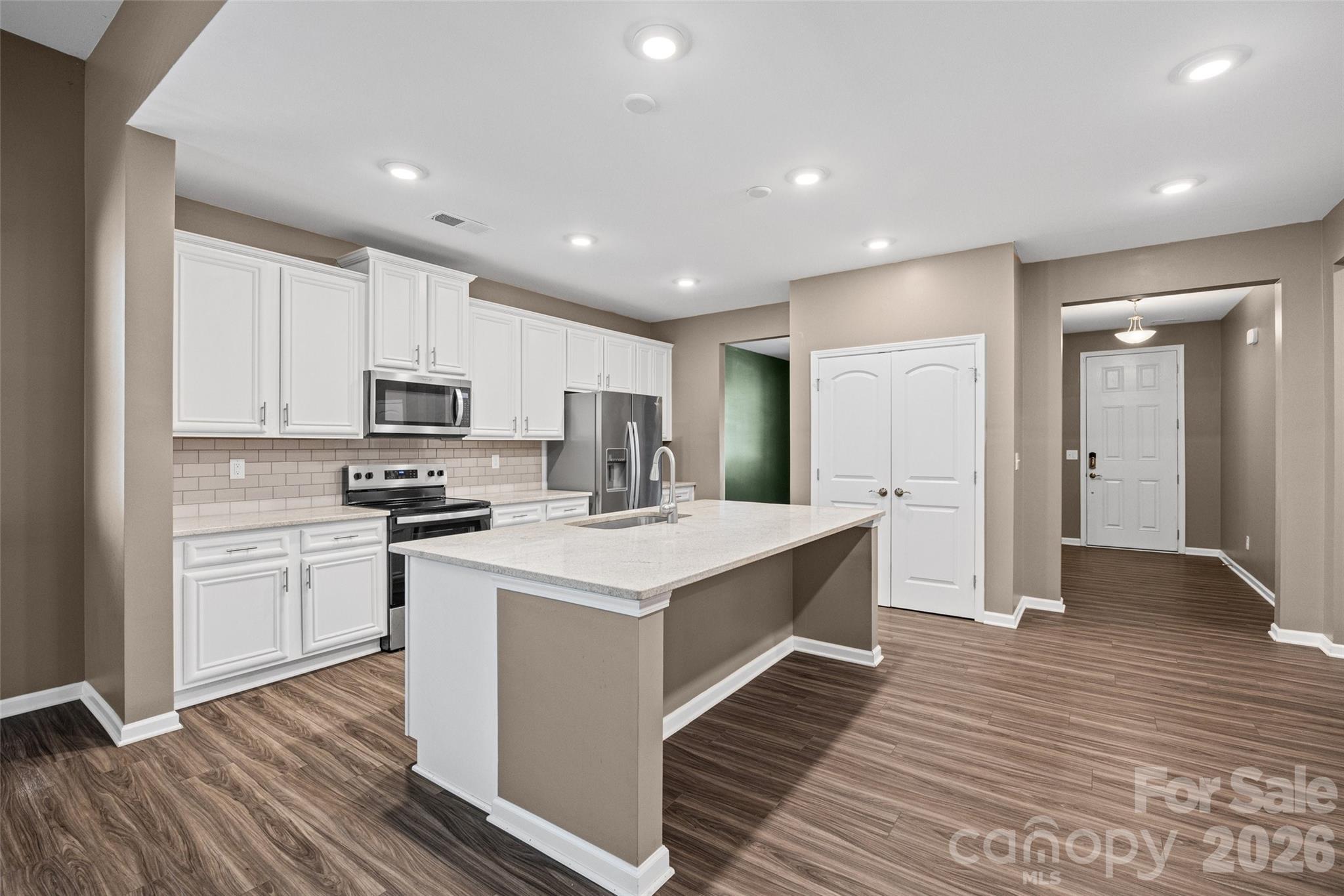 Large center island creates the perfect gathering spot for casual meals, entertaining, or simply keeping everyone together while cooking. - 596 Rustlewood Way, Rock Hill