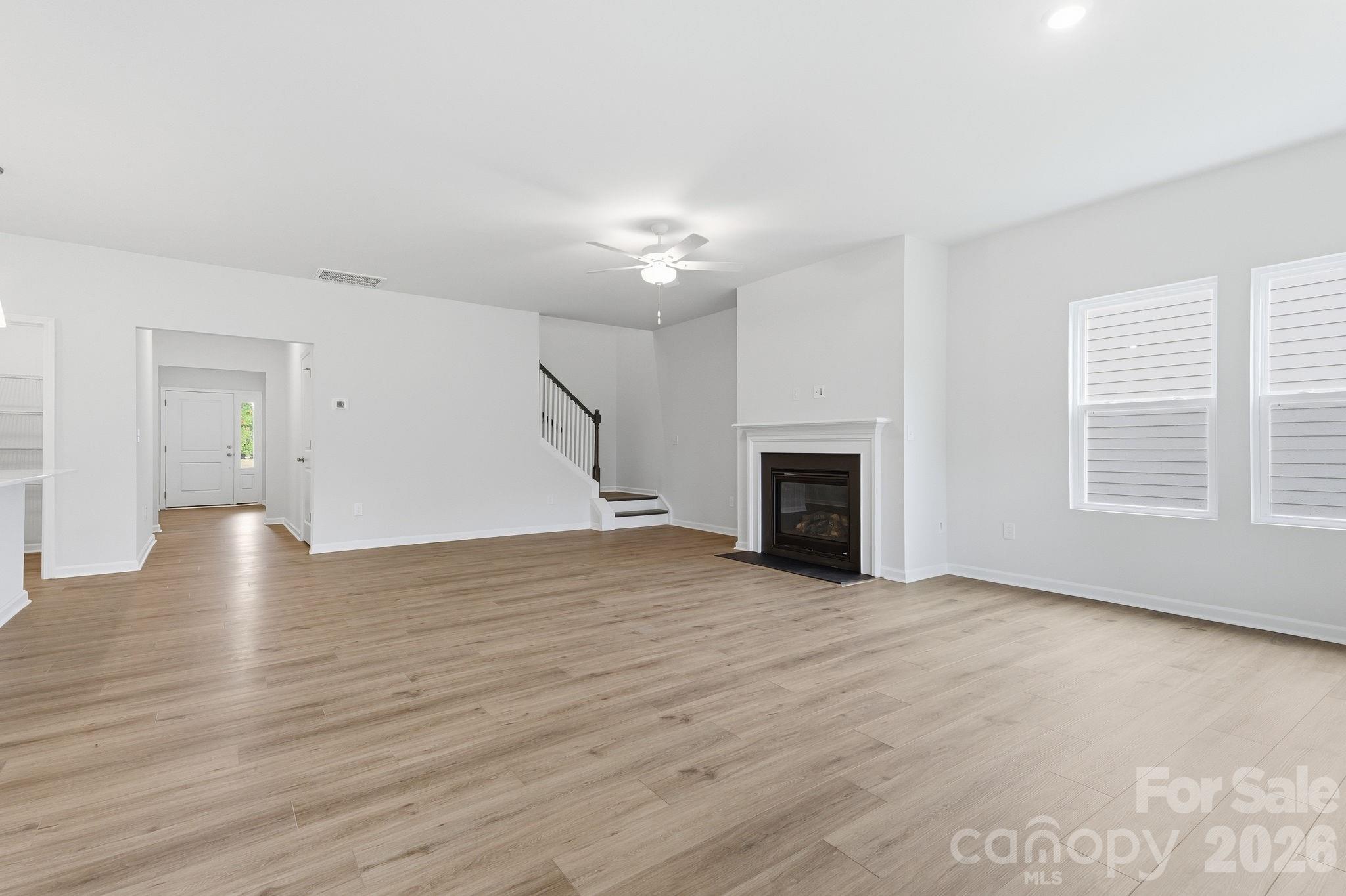 Fireplace and stairs to bonus room - 204 Rodeo Drive, Shelby