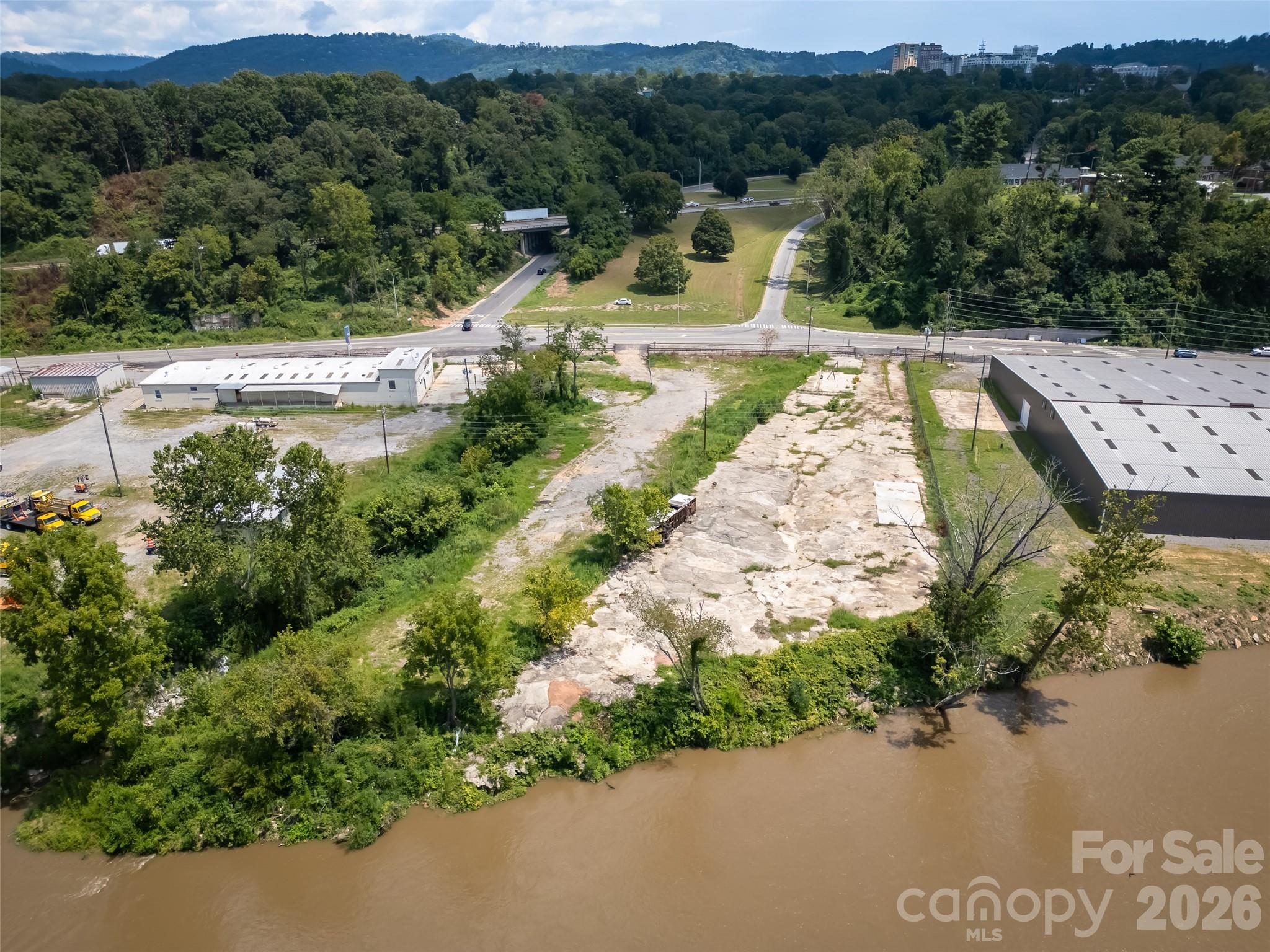 From the river side of property looking back towards I-26 / Hwy 19. - 458 Riverside Drive, Asheville