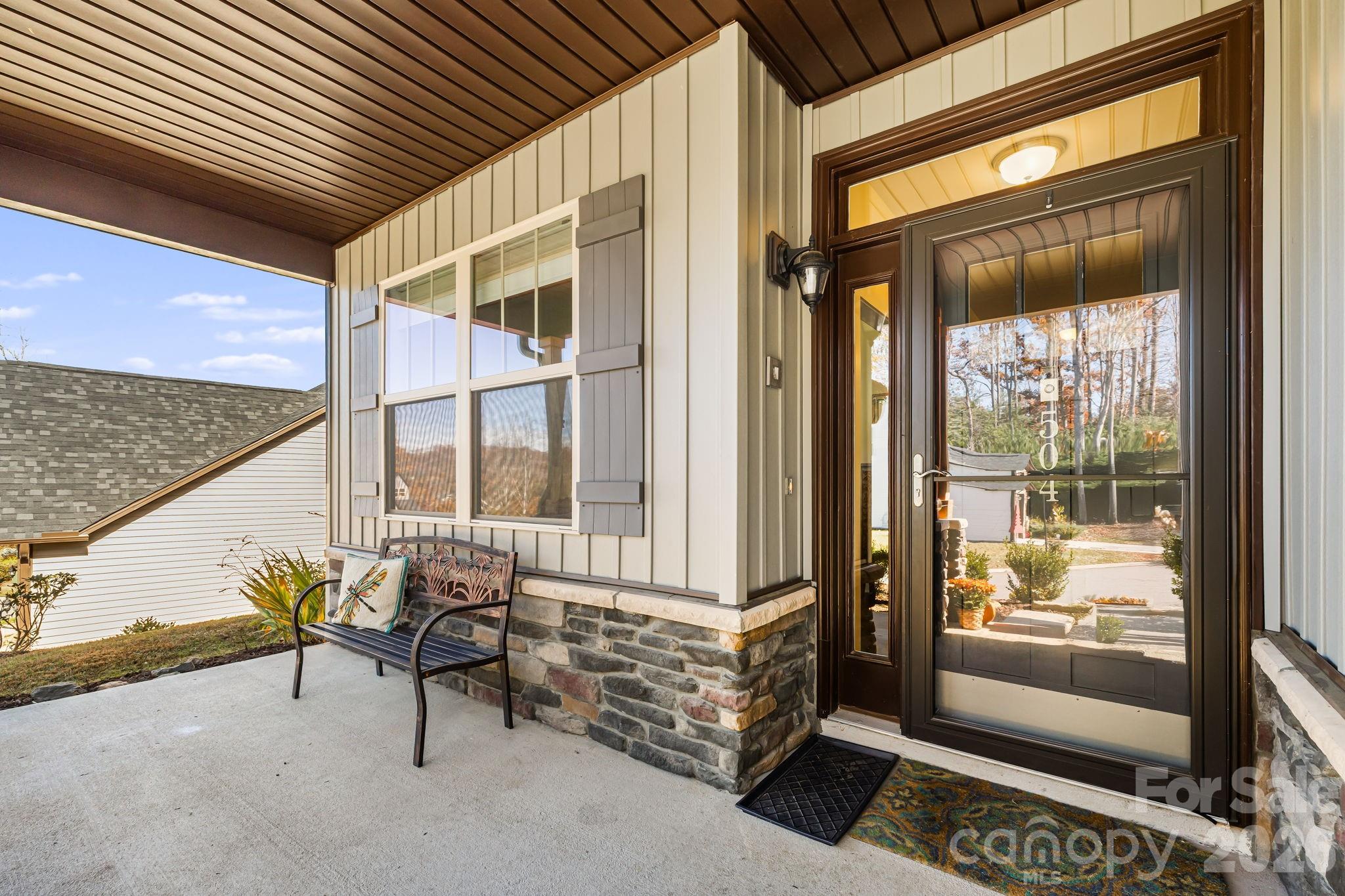 Front Porch with Stone accents and a glass door in front of the main door - 504 Rosebud Orchid Way, Weaverville