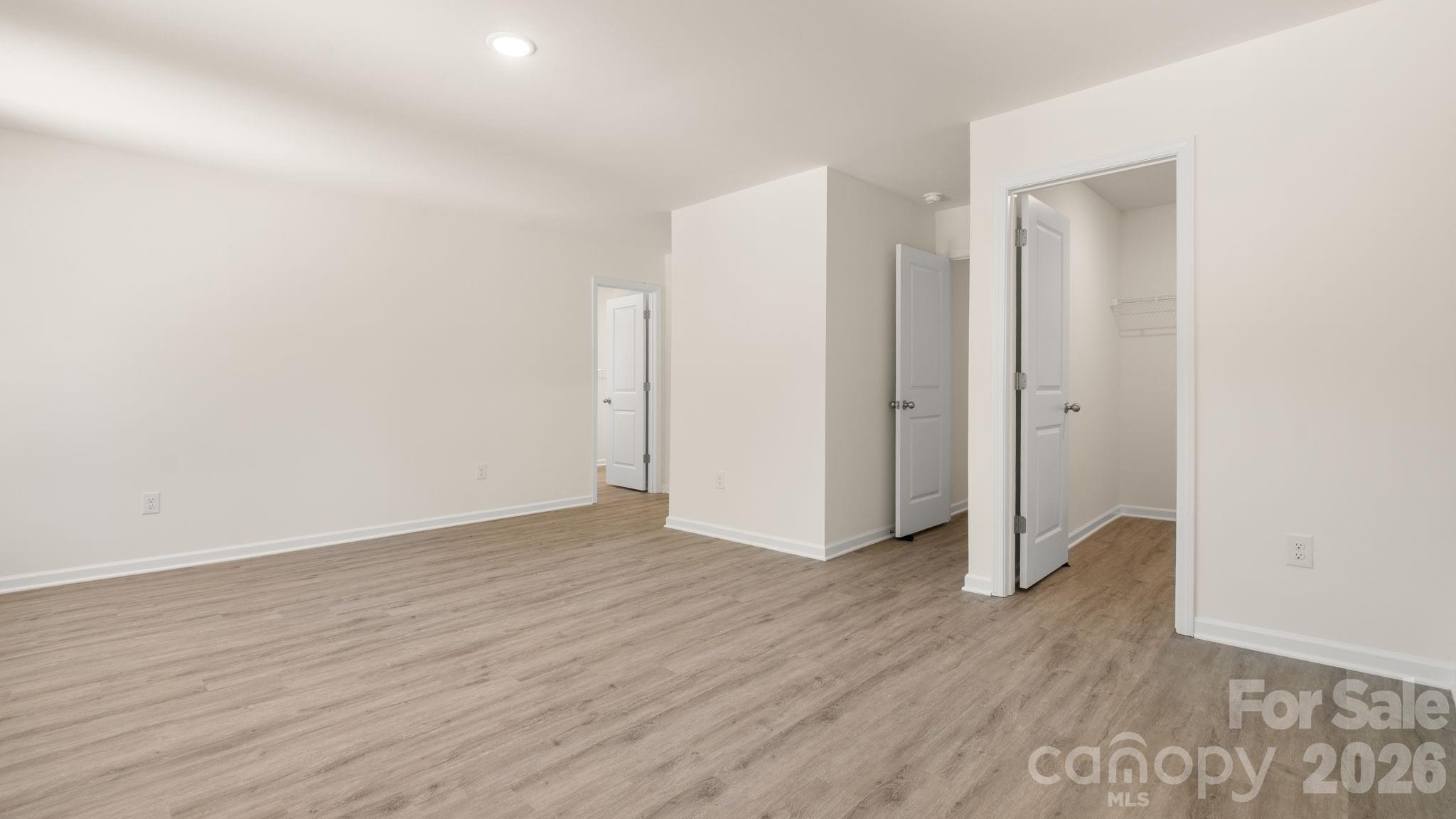 Primary Bedroom with dual walk-in closets. - 4029 Rolling Creek Drive, Vale