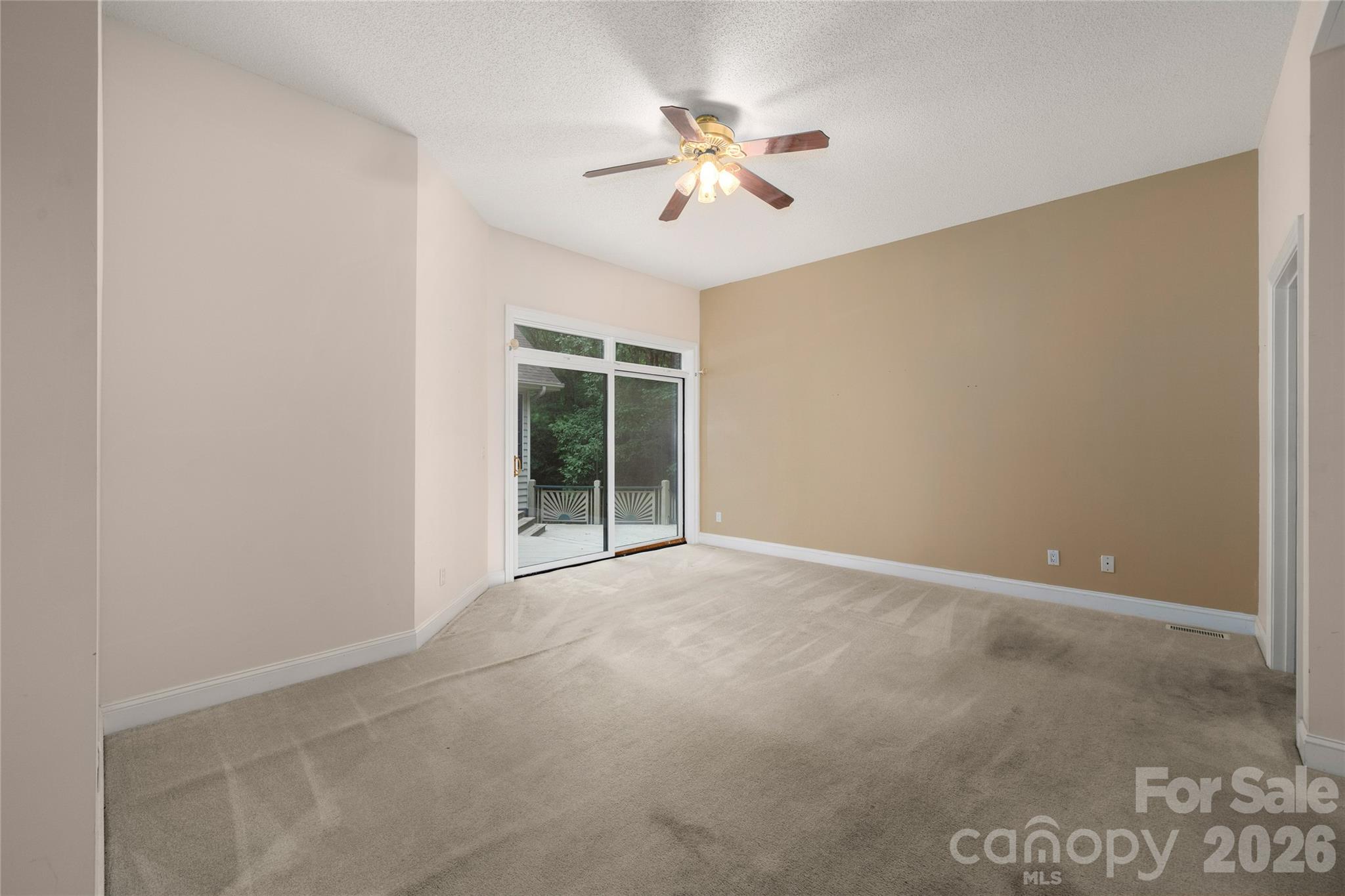 Primary bedroom with sliding glass doors to the deck - 136 Rumbling Bald Road, Lake Lure