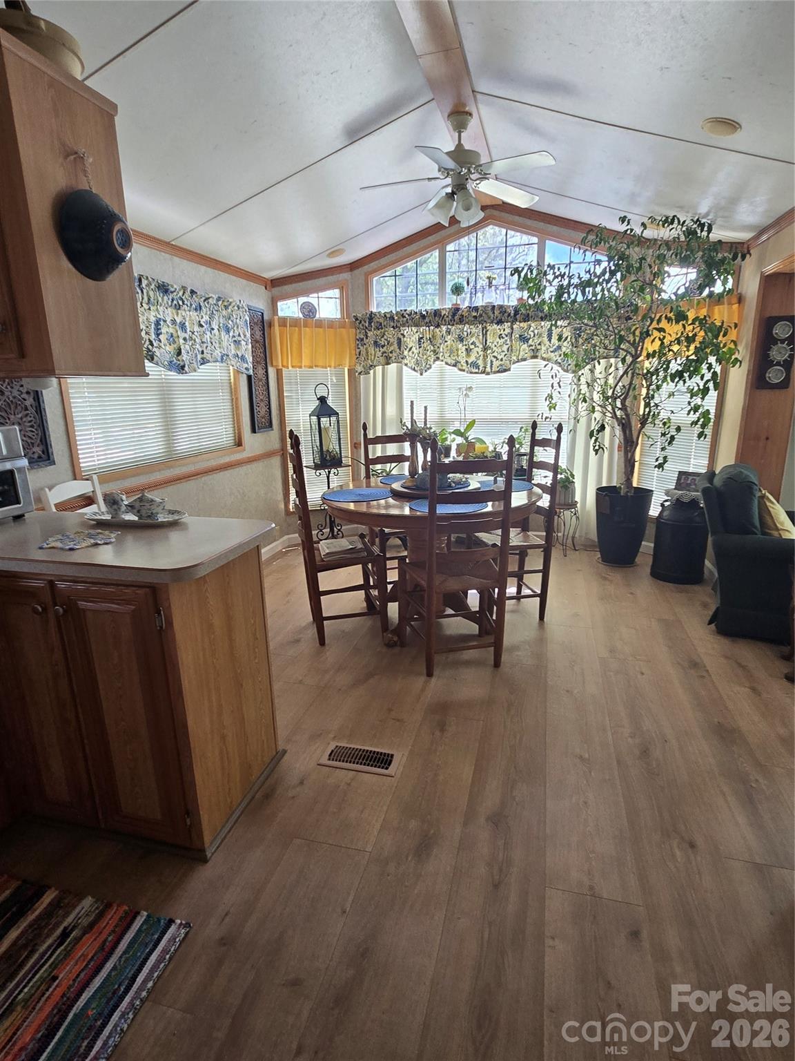 From kitchen into dining area with bay window in front of the Breckenridge Park model home - 110 Twin Bluff Trail, Mount Gilead