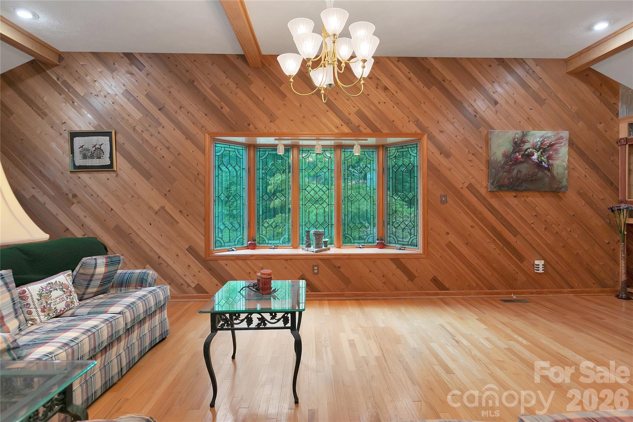 Wide open spaces are yours with the open concept of the living room! Stylish wood features everywhere.! Stained-glass bay windows look out to the lush green surroundings around this house! - 275 Hubbard Hollow Road, Rosman