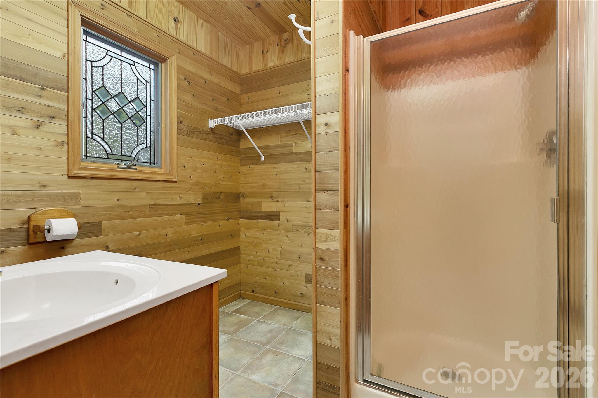 This is the second, full, bathroom beside the mud room and the garage. Come in the back door from the Lady Bugs Custom Fountain Waterfall (unfinished). Shower and head on inside! Stained Glass window here as well! - 275 Hubbard Hollow Road, Rosman