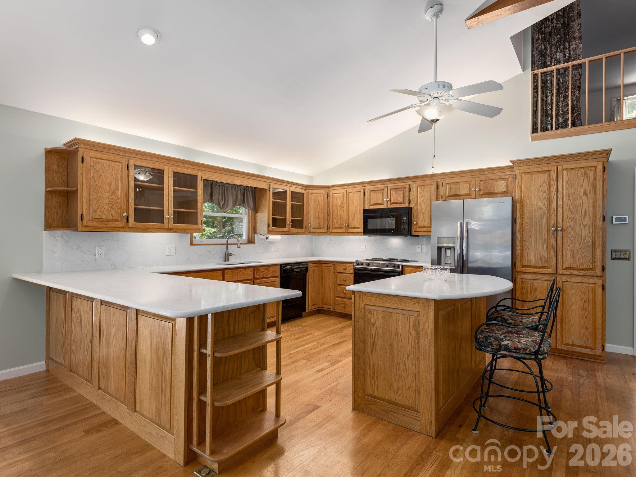 Updated countertops add a fresh, stylish touch to the kitchen. - 1572 Brushy Fork Road, Sylva