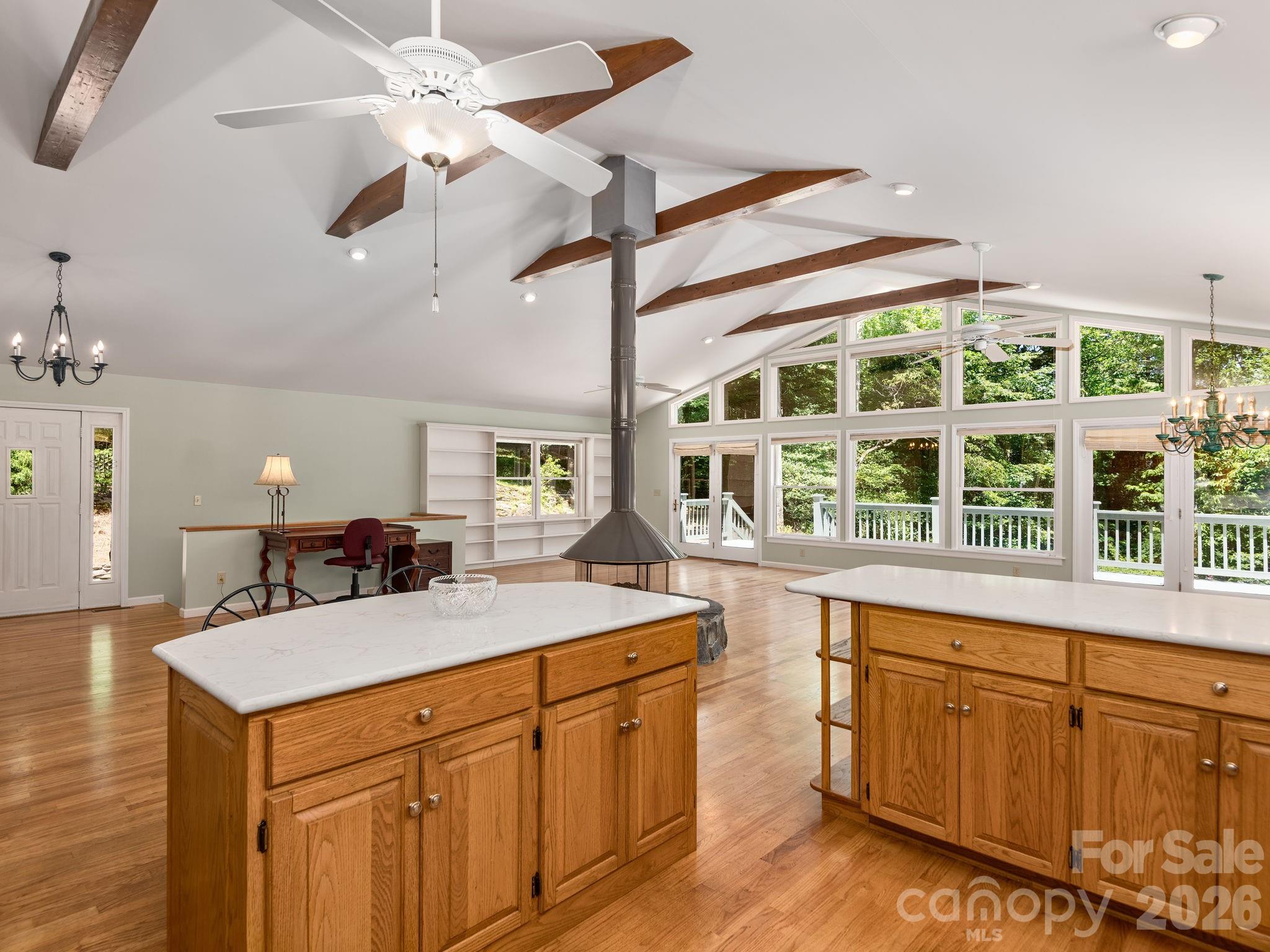 Embrace mountain living in this charming home, where a stunning wall of windows welcomes the beauty of the outdoors inside. - 1572 Brushy Fork Road, Sylva