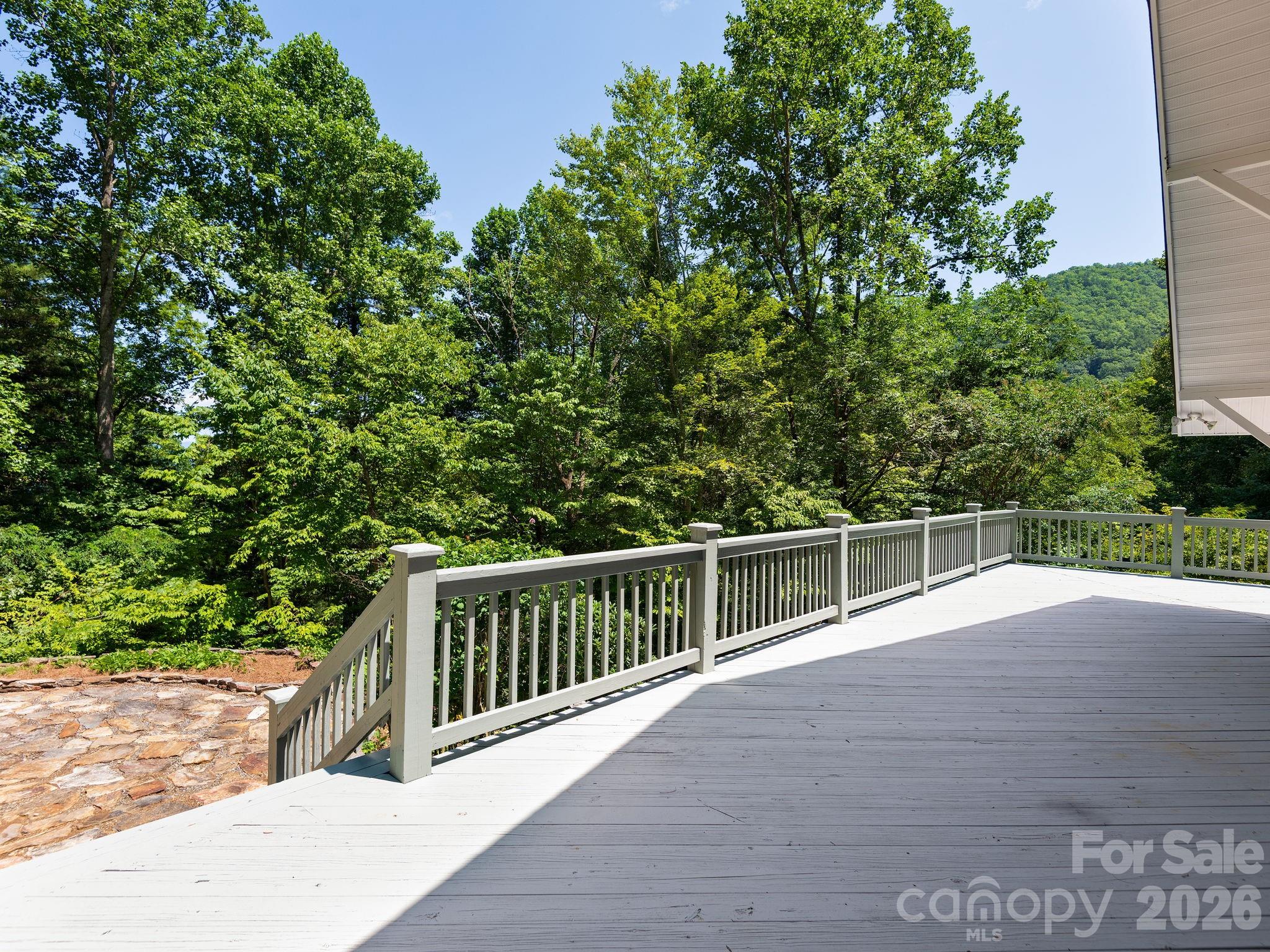 Expansive 684-square-foot deck with easy access from both the dining area and great room—perfect for outdoor living and entertaining. - 1572 Brushy Fork Road, Sylva