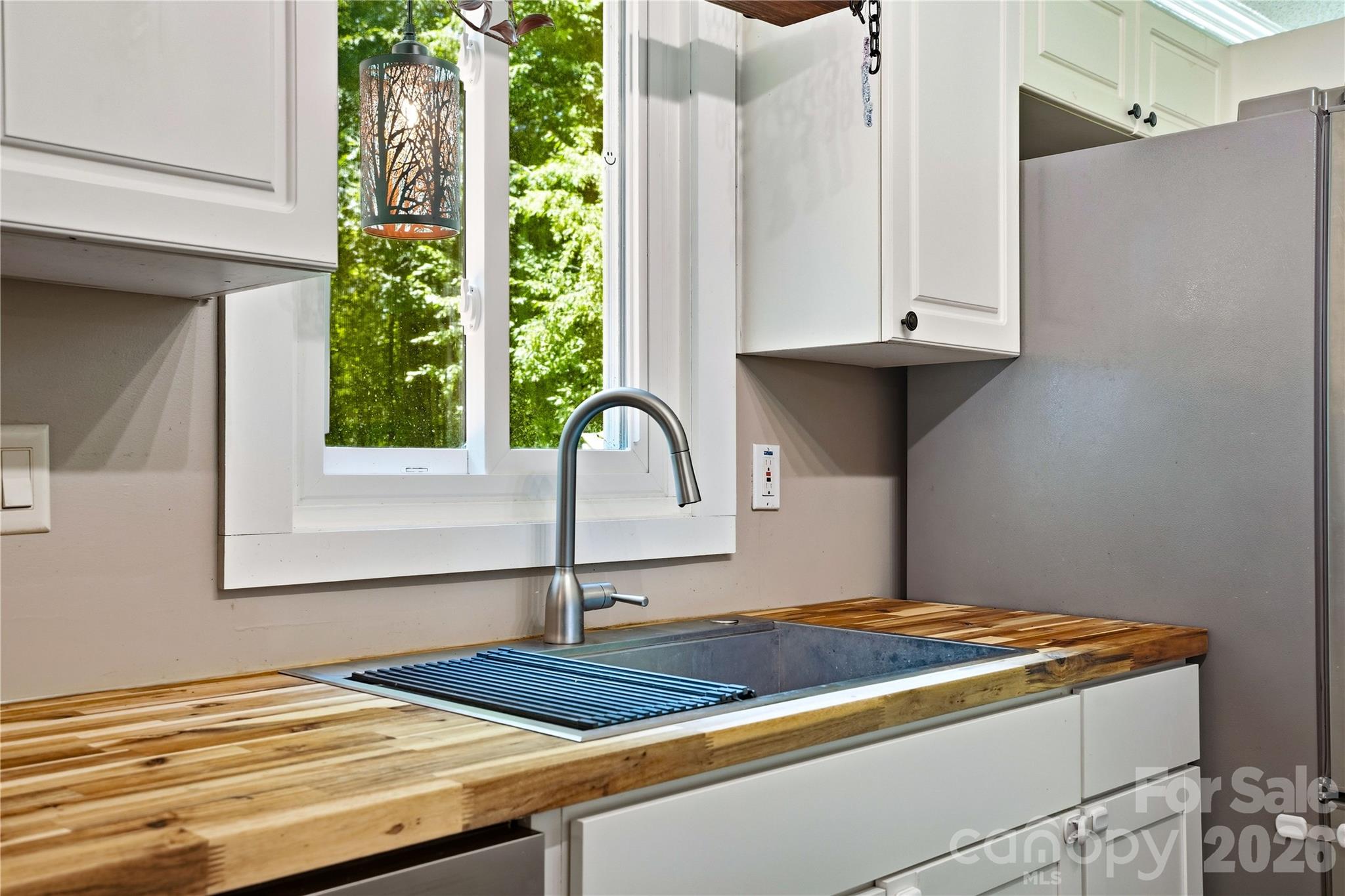 Sink overlooking back garden area and new butcher block countertop. - 3555 Lake Bluff Drive, Sherrills Ford