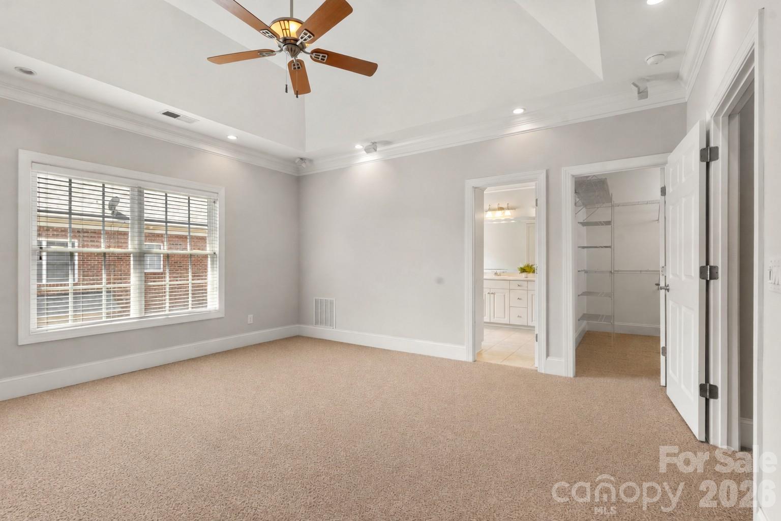 Spacious primary suite with tray ceiling. - 705 Congressional Lane, Fort Mill