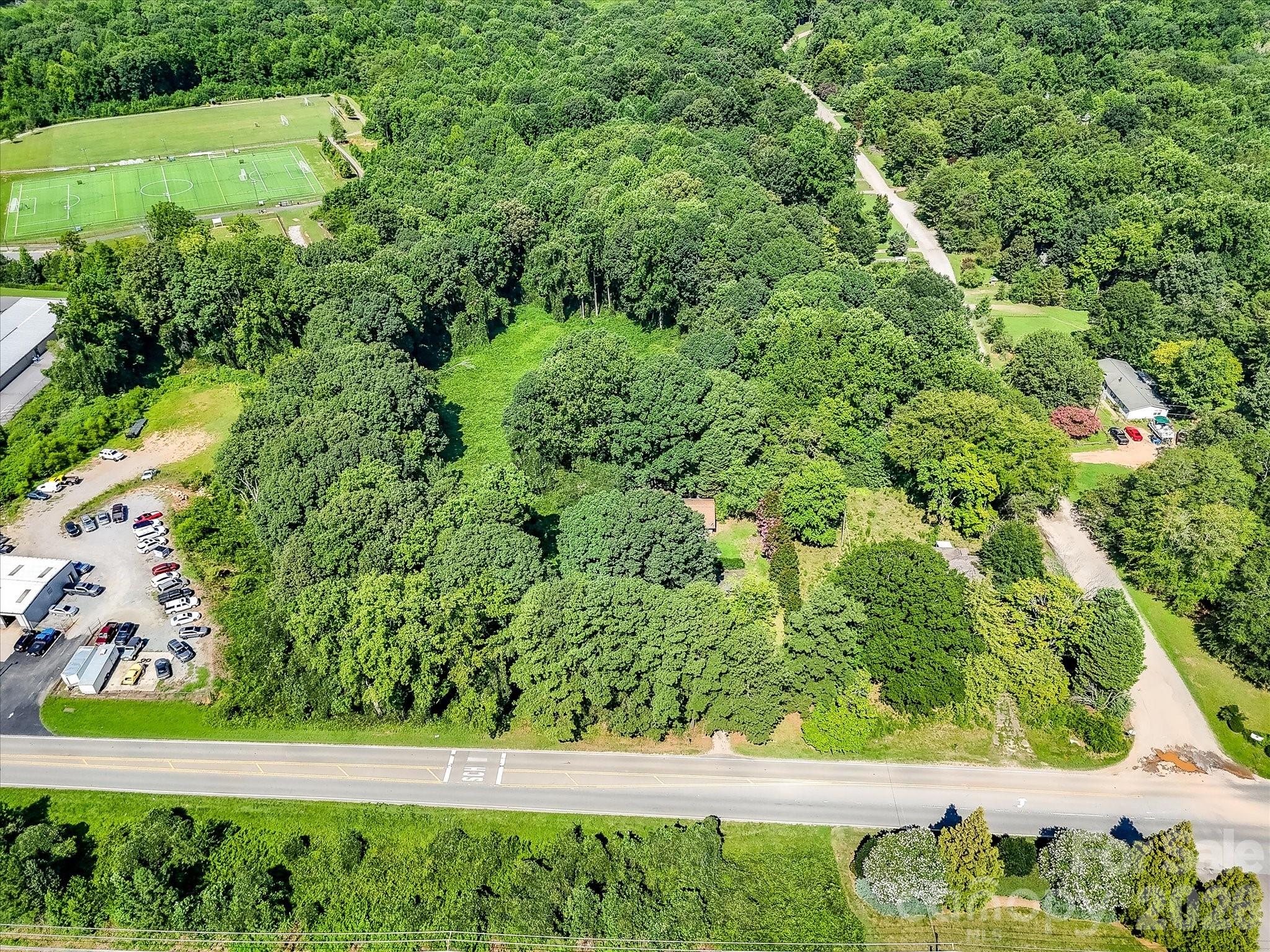 Expansive aerial view showcasing the property's generous acreage, natural landscape, and strategic location within Denver's rapidly growing business district. - 1753 N NC Hwy 16 Business Highway, Denver