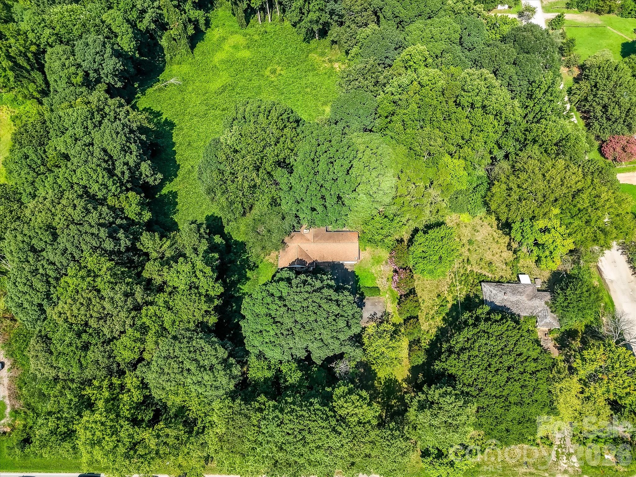 Expansive aerial view showcasing the property's generous acreage, natural landscape, and strategic location within Denver's rapidly growing business district. - 1753 N NC Hwy 16 Business Highway, Denver
