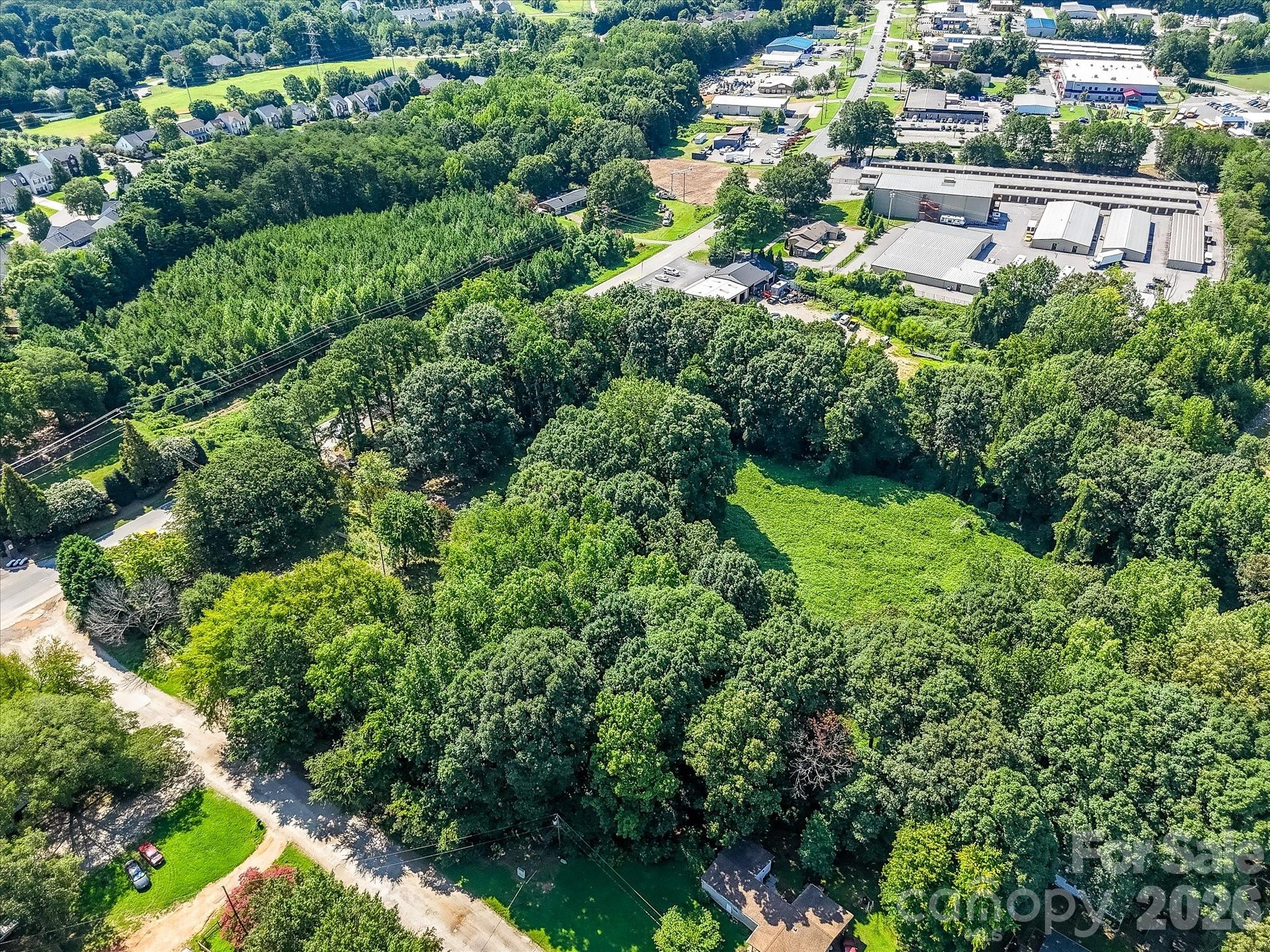 Expansive aerial view showcasing the property's generous acreage, natural landscape, and strategic location within Denver's rapidly growing business district. - 1753 N NC Hwy 16 Business Highway, Denver