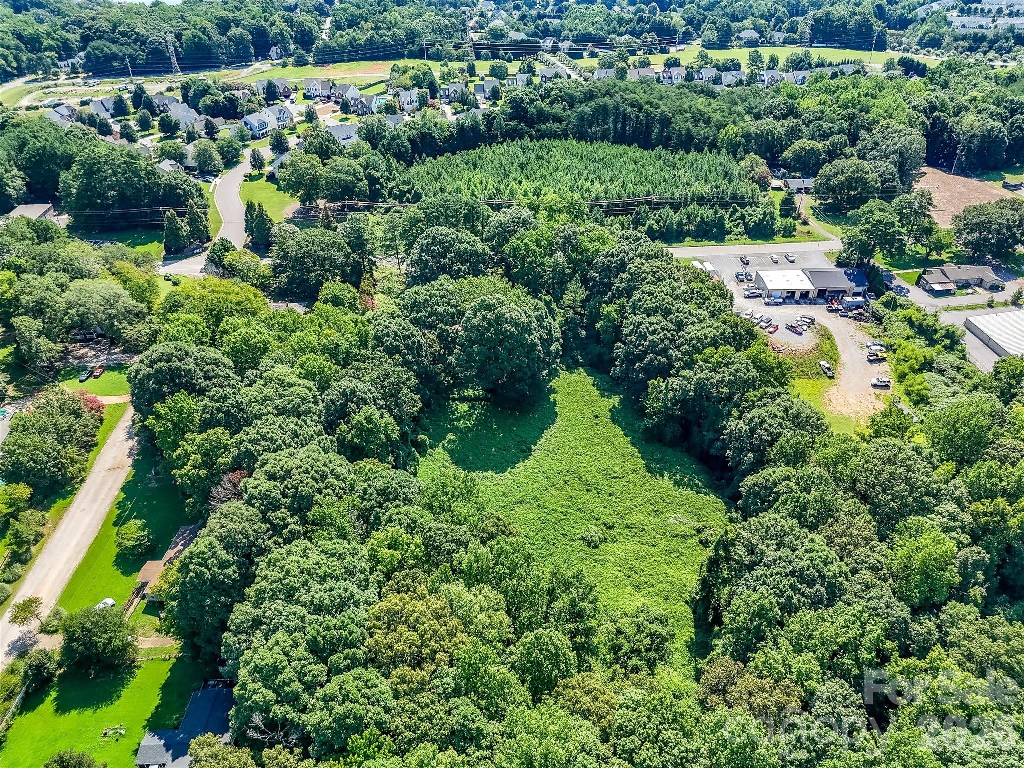 This Denver, NC commercial opportunity features a large, wooded parcel with existing improvements and exceptional redevelopment potential in one of the fastest-growing areas. - 1753 N NC Hwy 16 Business Highway, Denver
