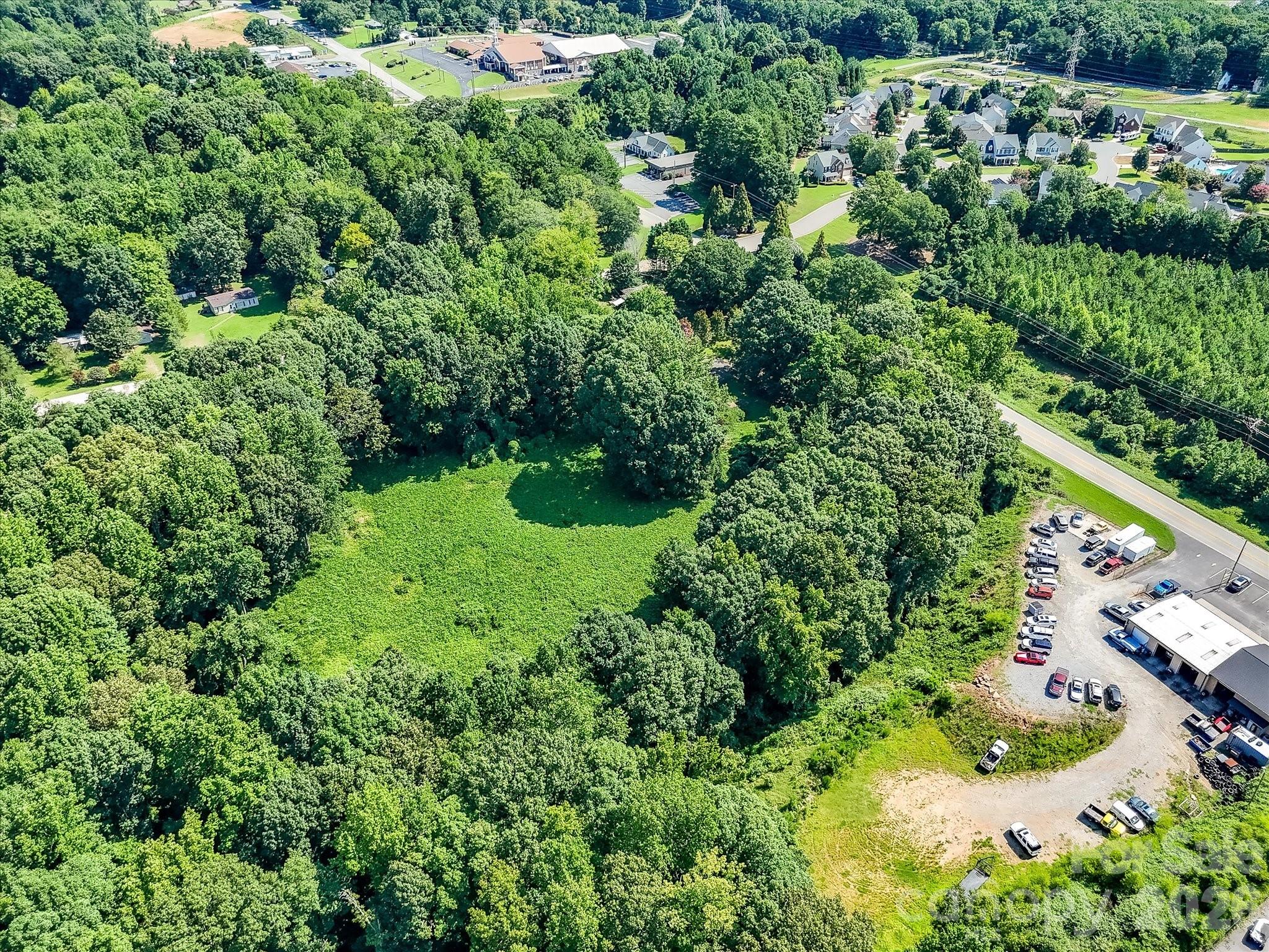 Expansive aerial view showcasing the property's generous acreage, natural landscape, and strategic location within Denver's rapidly growing business district. - 1753 N NC Hwy 16 Business Highway, Denver