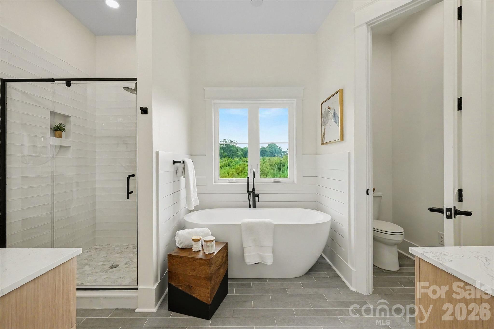 Welcome to your bathroom oasis with custom walk-in shower, soaking tub and private water closet. - 6609 McNeely Road, Waxhaw